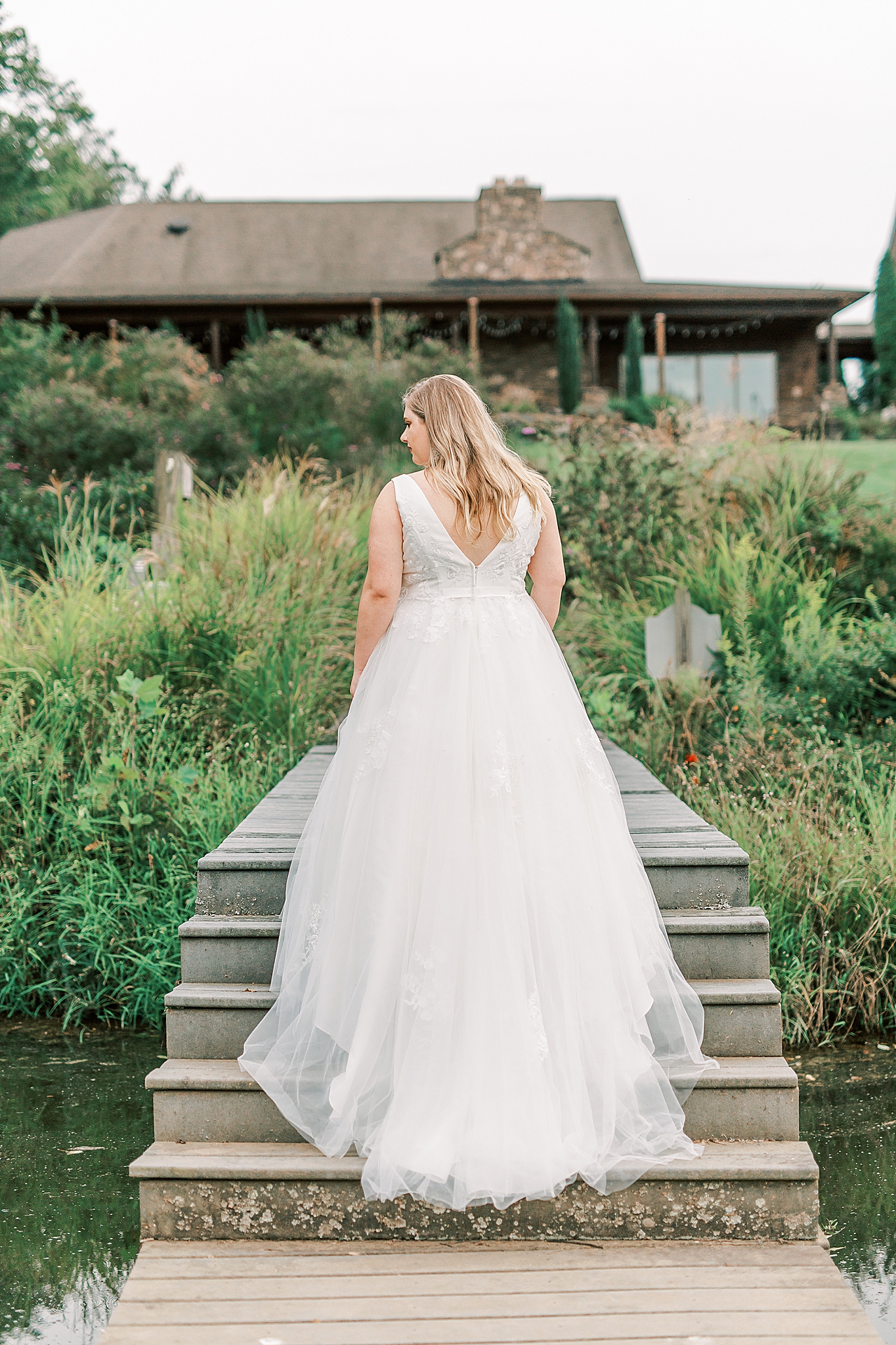 bride stands on steps during The Arbors Bridal Portraits
