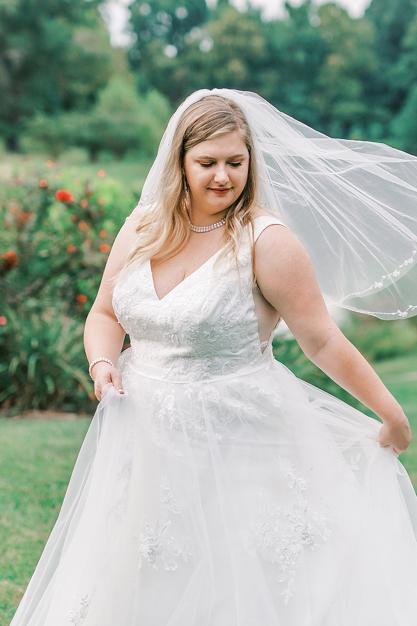 bride twirls wedding dress with veil floating behind her