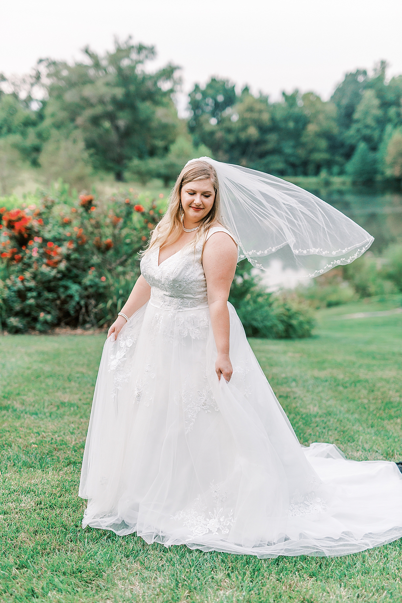 bride poses in gardens at The Arbors