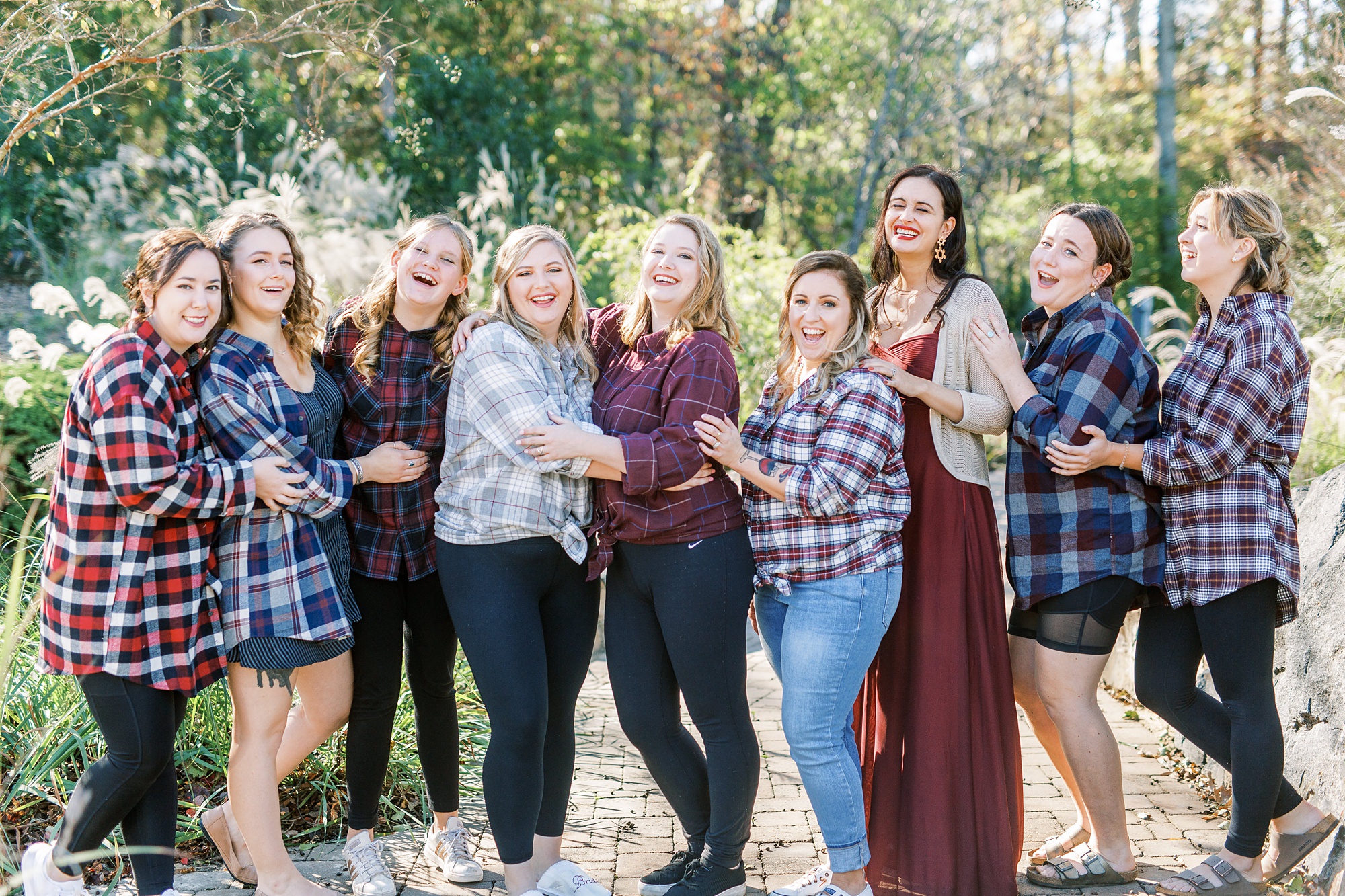 bridesmaids in mismatched plaid prepare for wedding