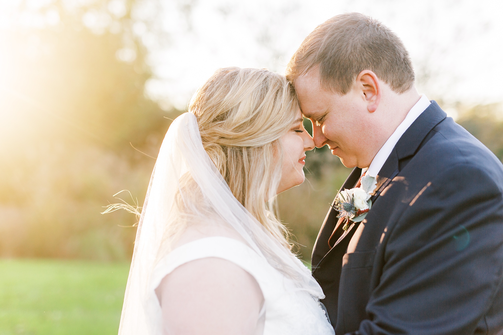 bride and groom stand nose to nose during NC wedding photos