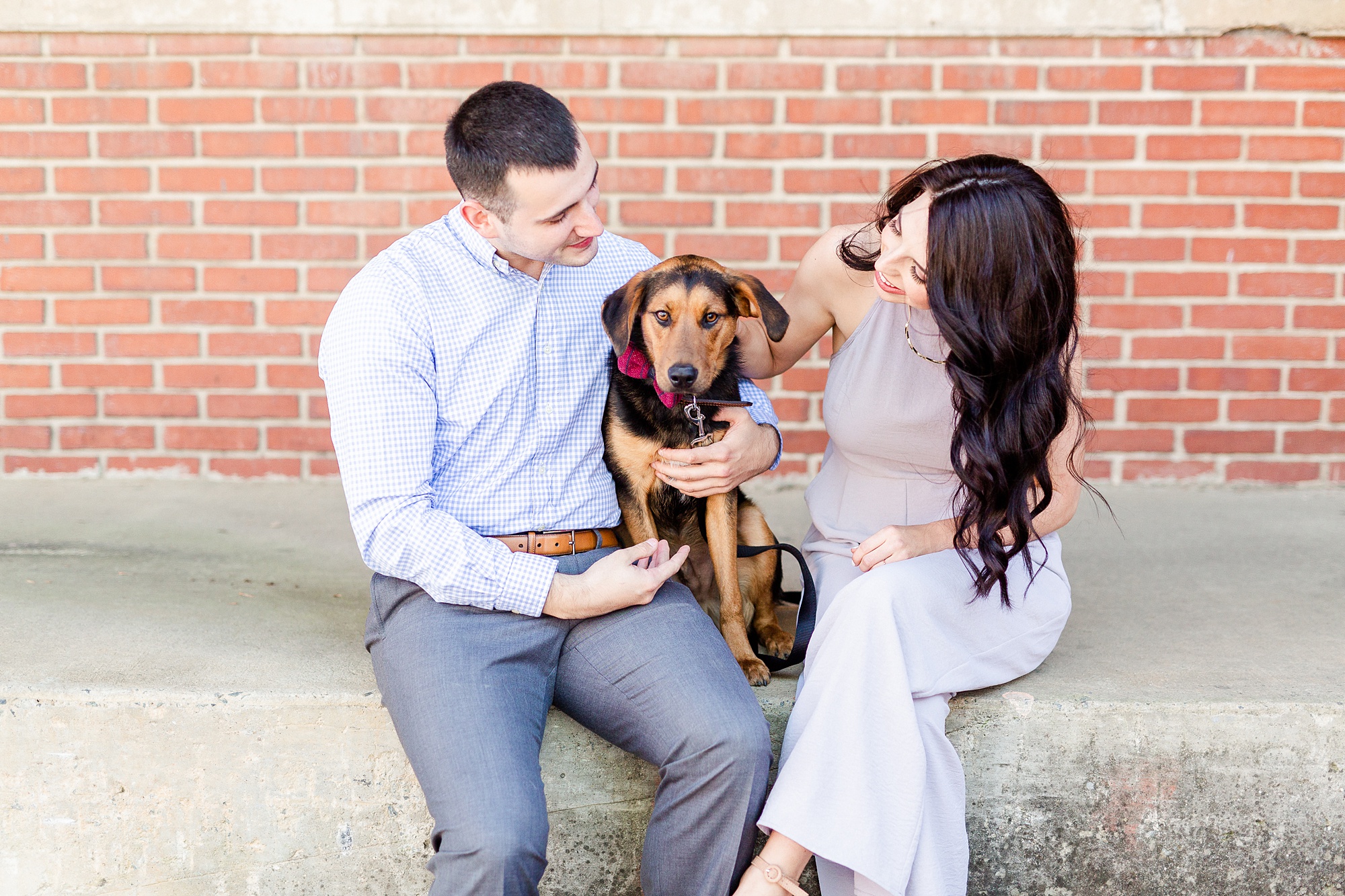 North Carolina couple plays with dog during CLT engagement photos