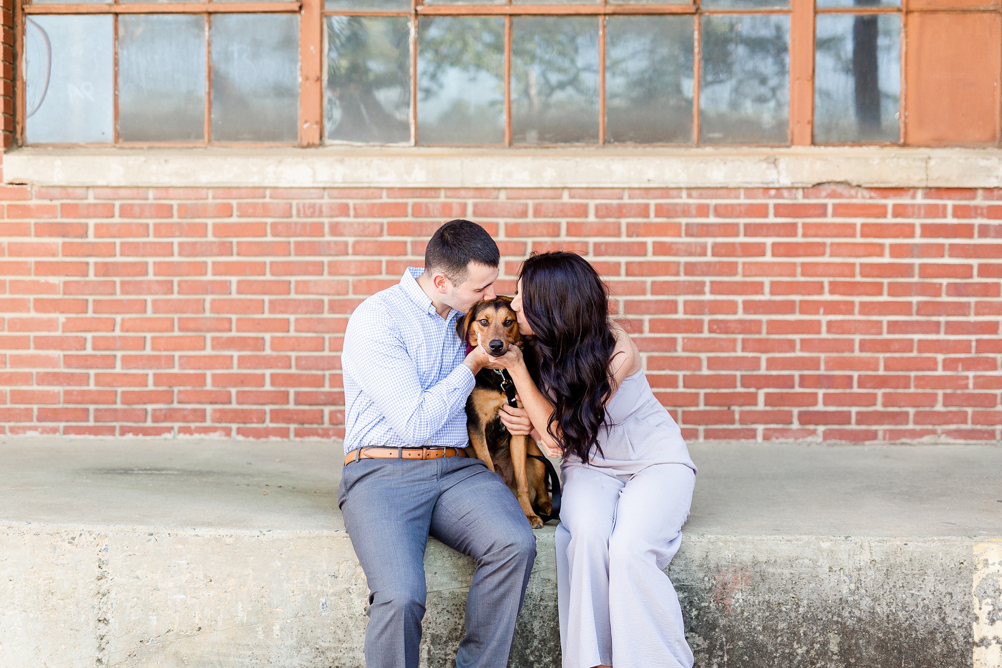 engaged couple poses with dog in Camp North End