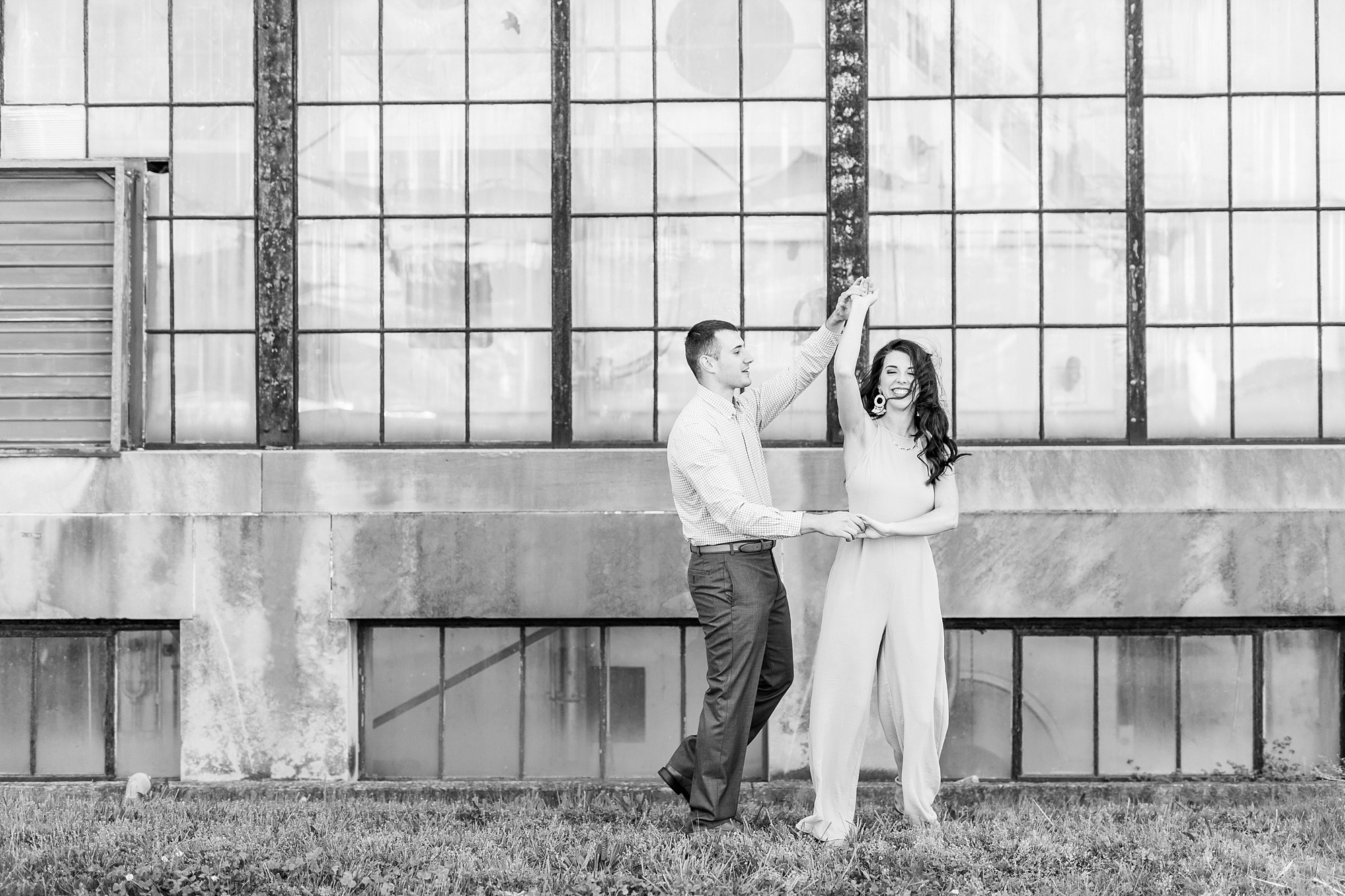 groom twirls bride during engagement photos in North Carolina
