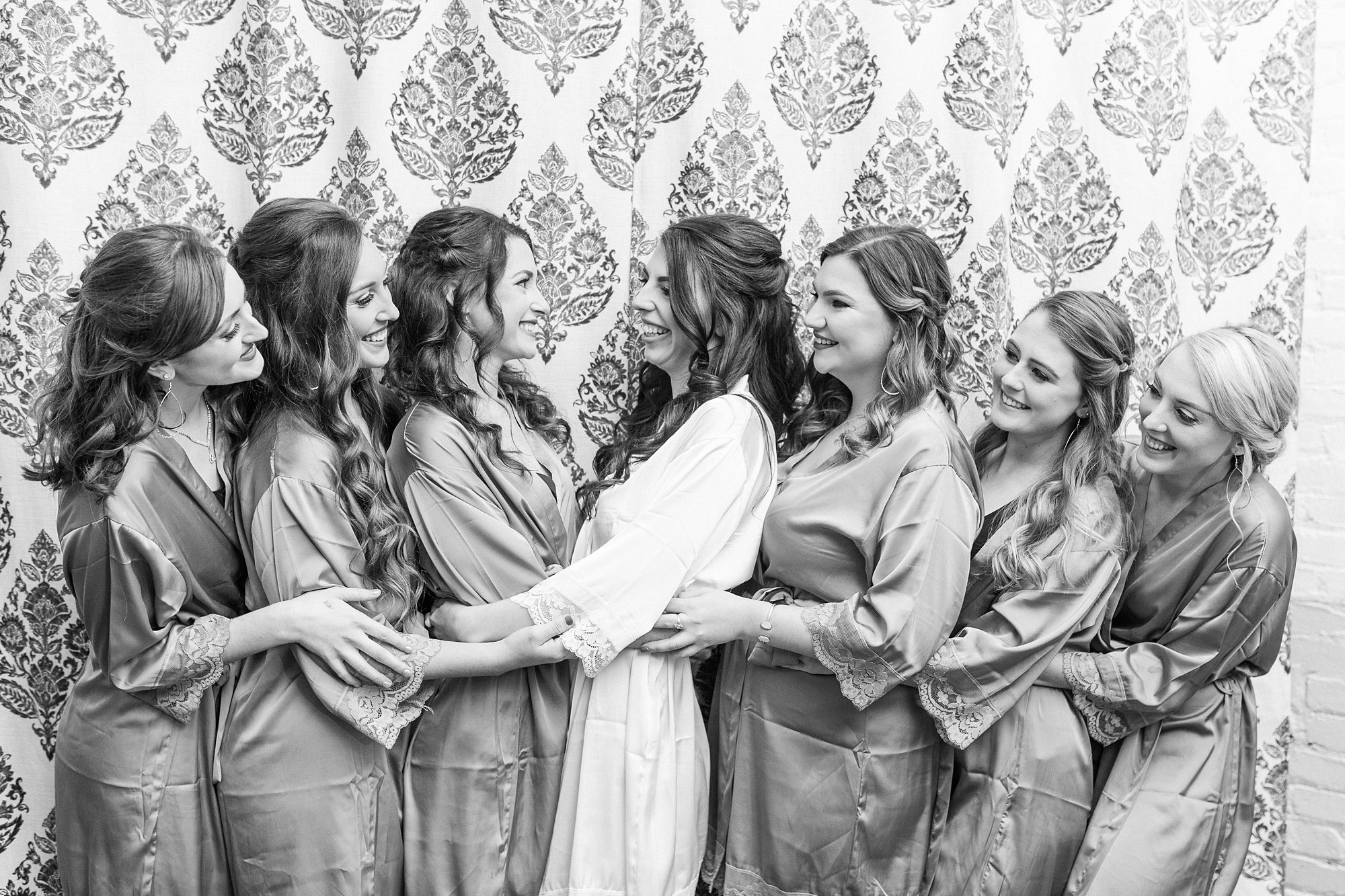 bridesmaids hug before Providence Cotton Mill wedding