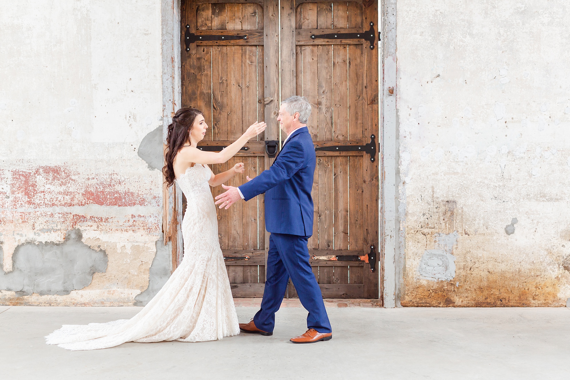 bride and dad go to hug each other during first look