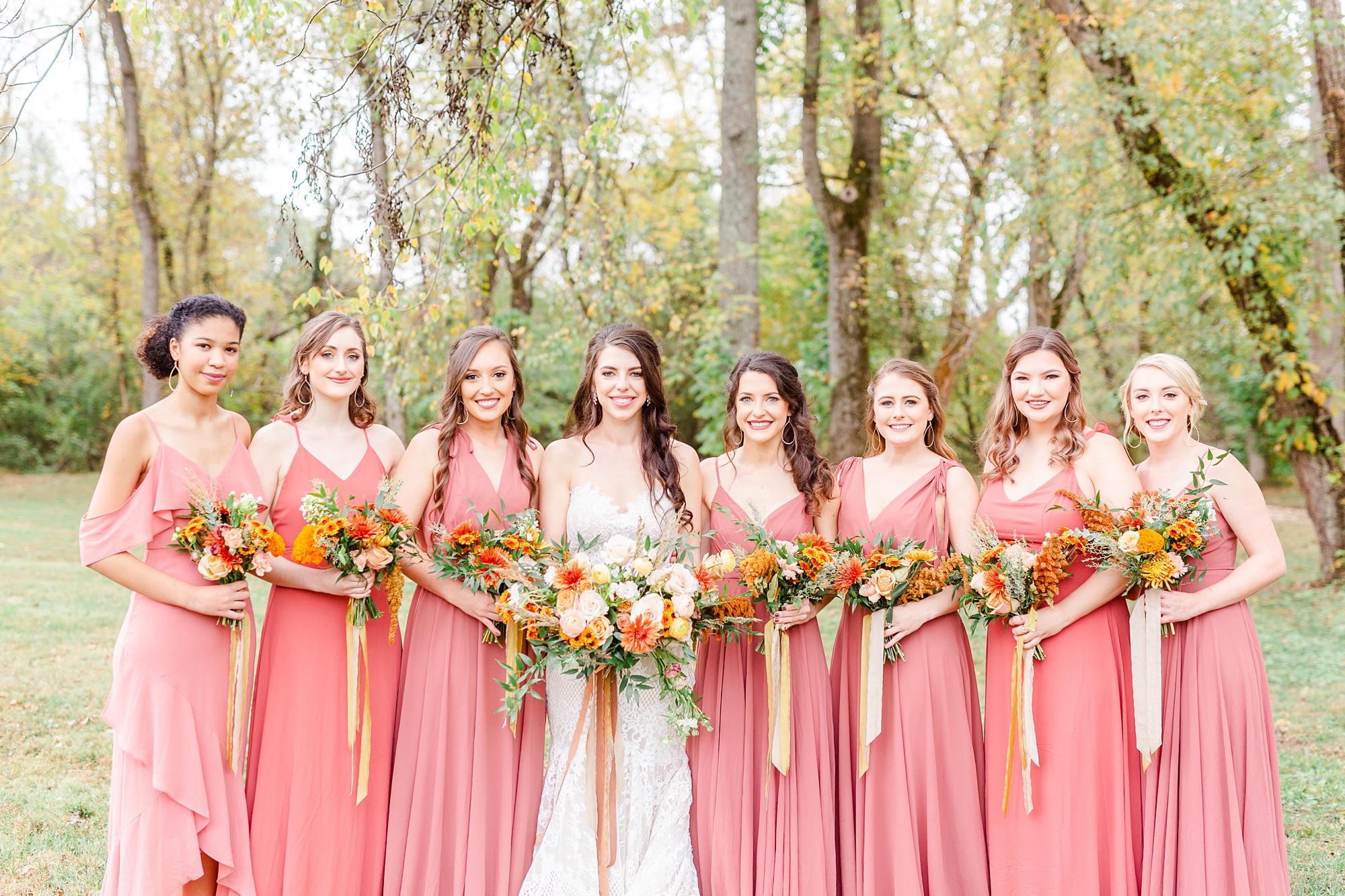 bride and bridesmaids in coral gowns pose in Maiden NC