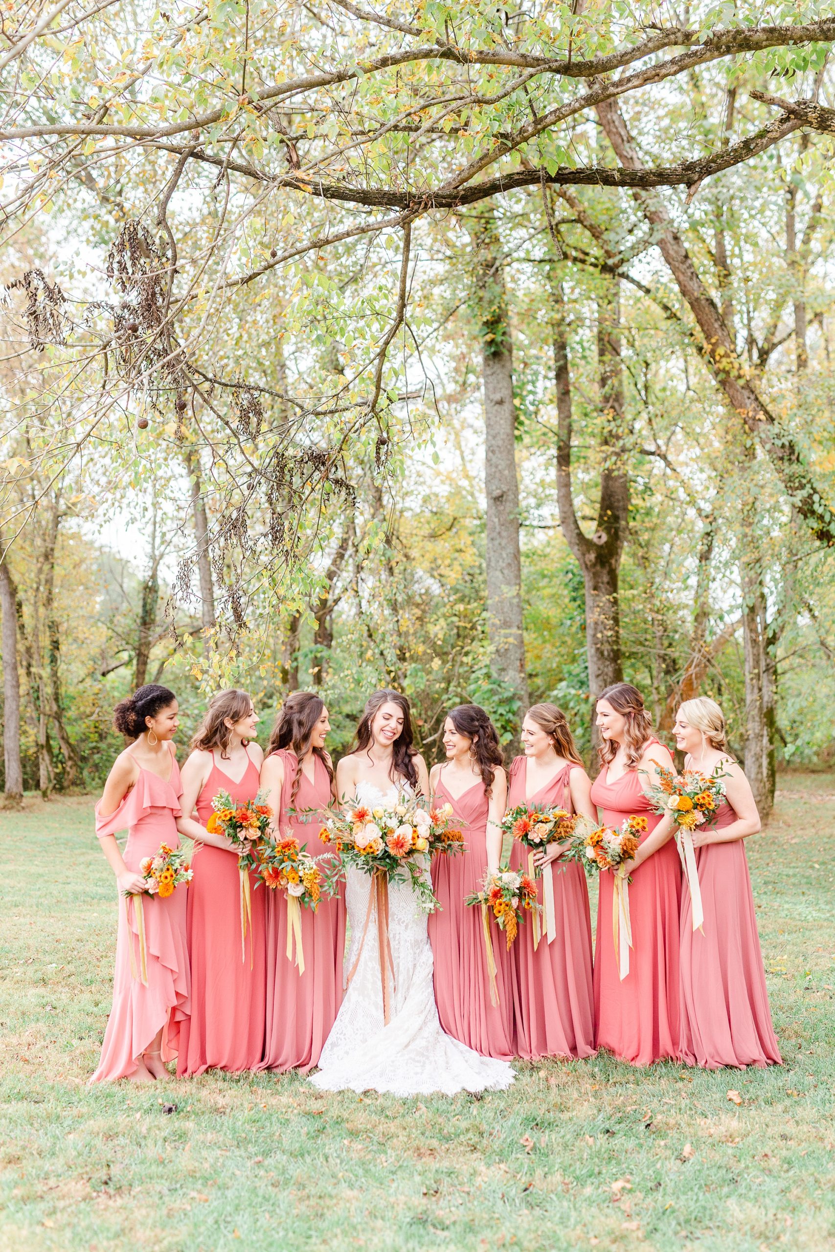 bride and bridesmaids in coral gowns pose in Maiden NC