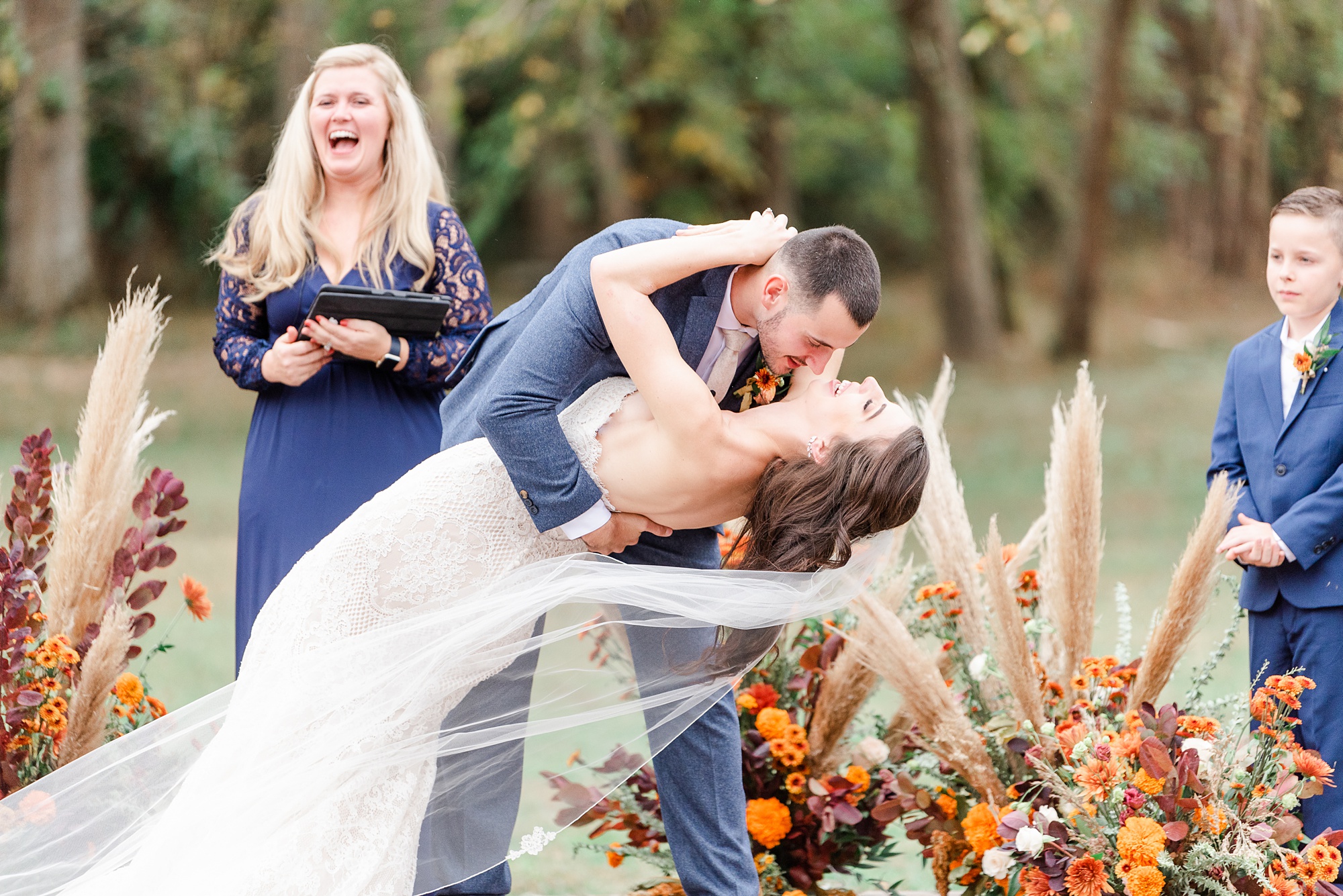 groom dips bride during ceremony kiss