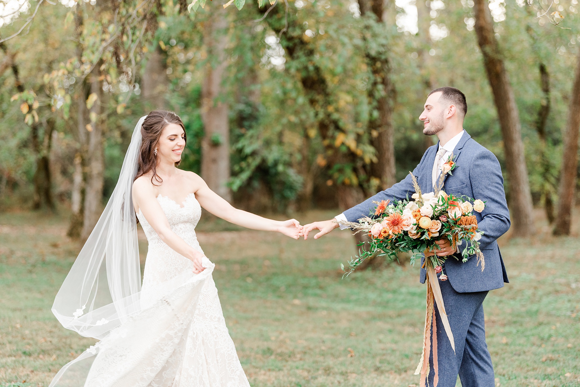 groom twirls bride while holding bouquet for her