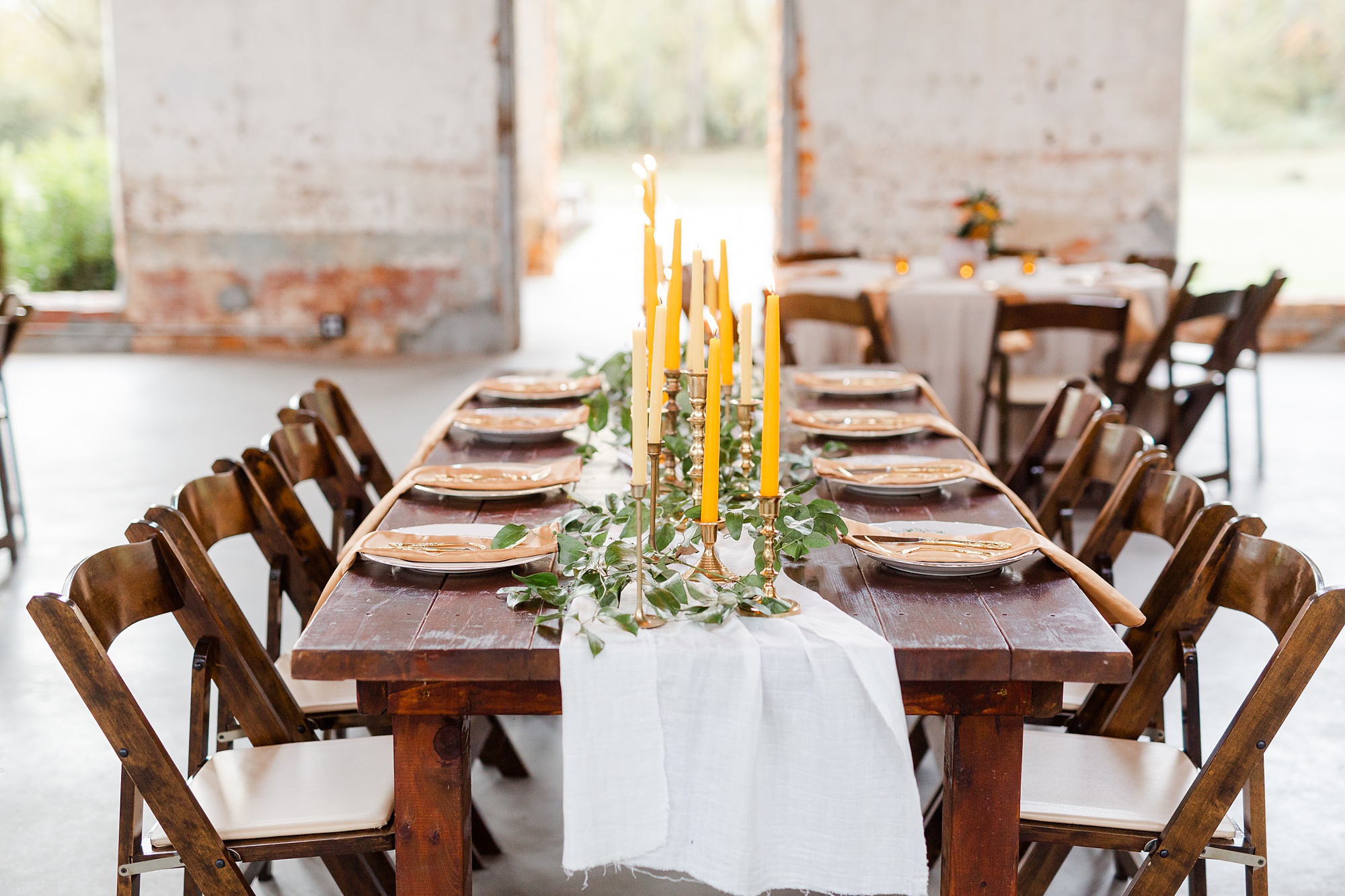 tables with gold candles and greenery at Providence Cotton Mill