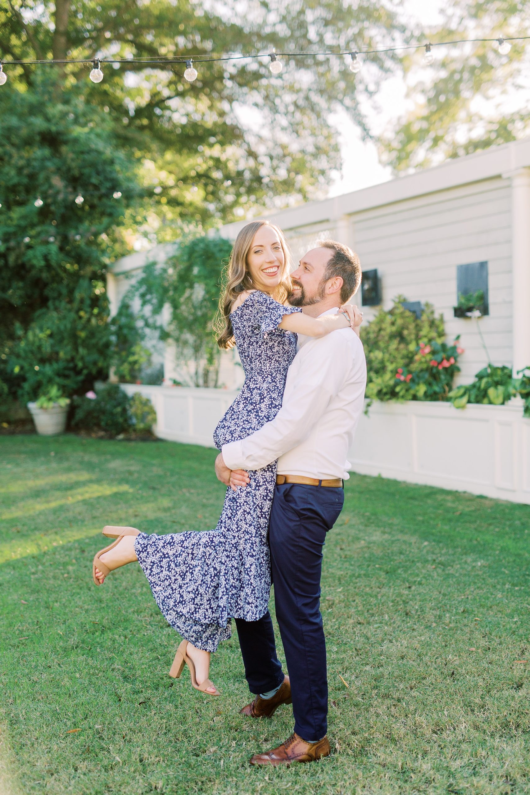 groom lifts bride up during Gastonia NC engagement photos