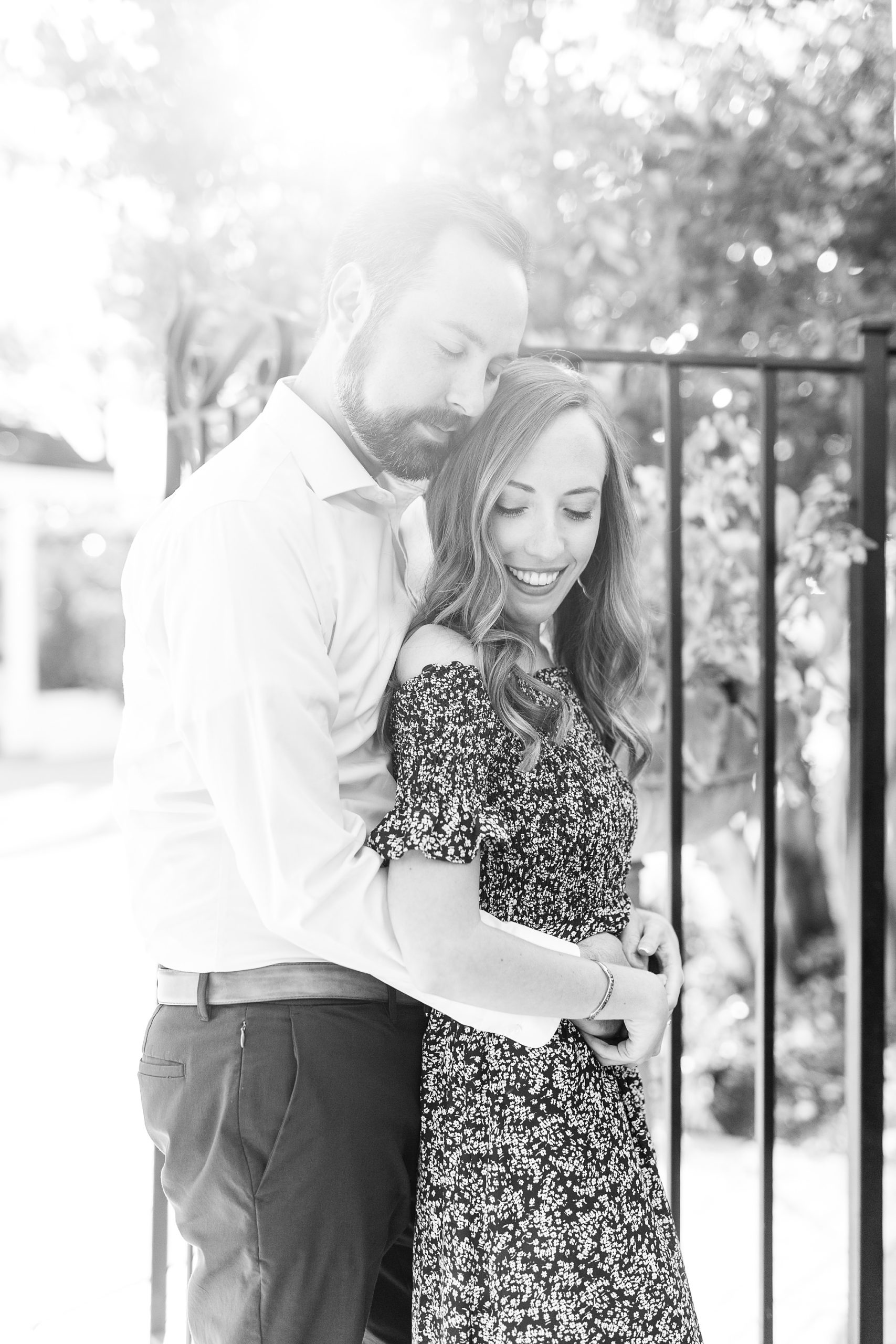 bride and groom pose by iron gate during Gastonia NC engagement session