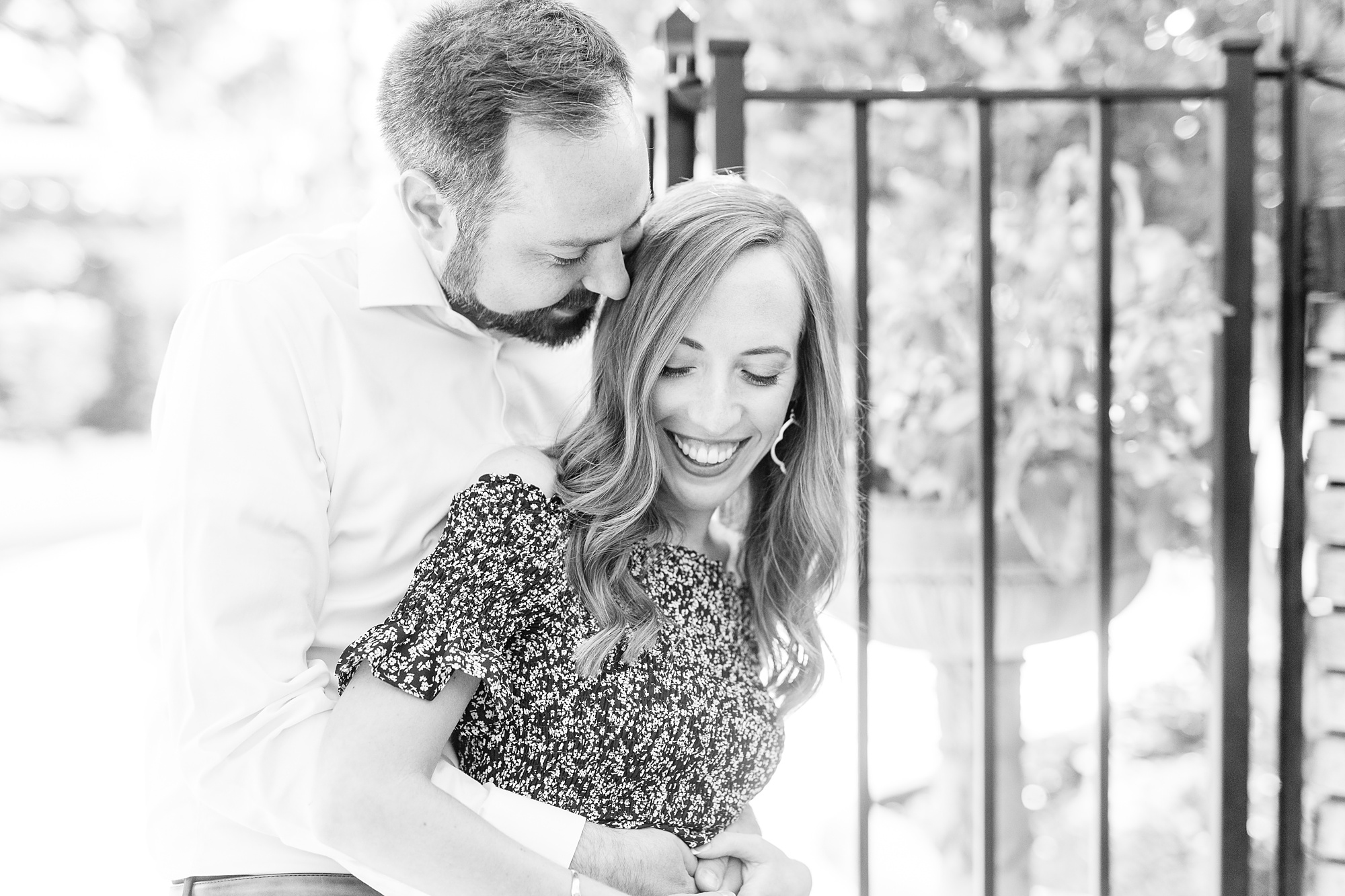 bride and groom pose by iron gate during Gastonia NC engagement session