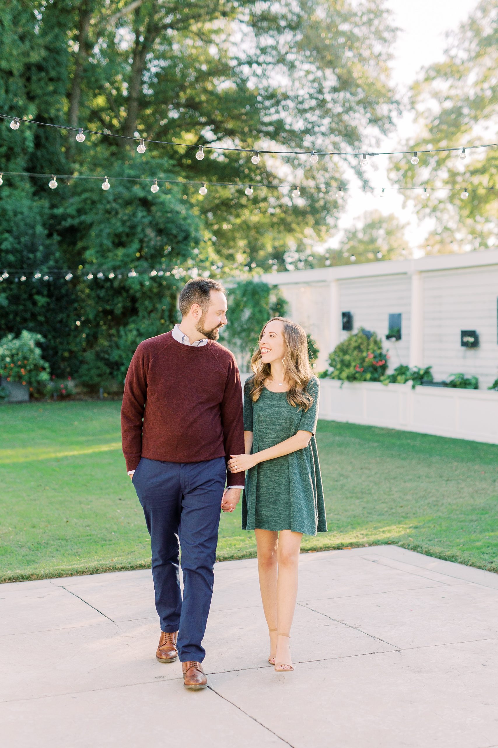 engaged couple walks through yard at Separk Mansion