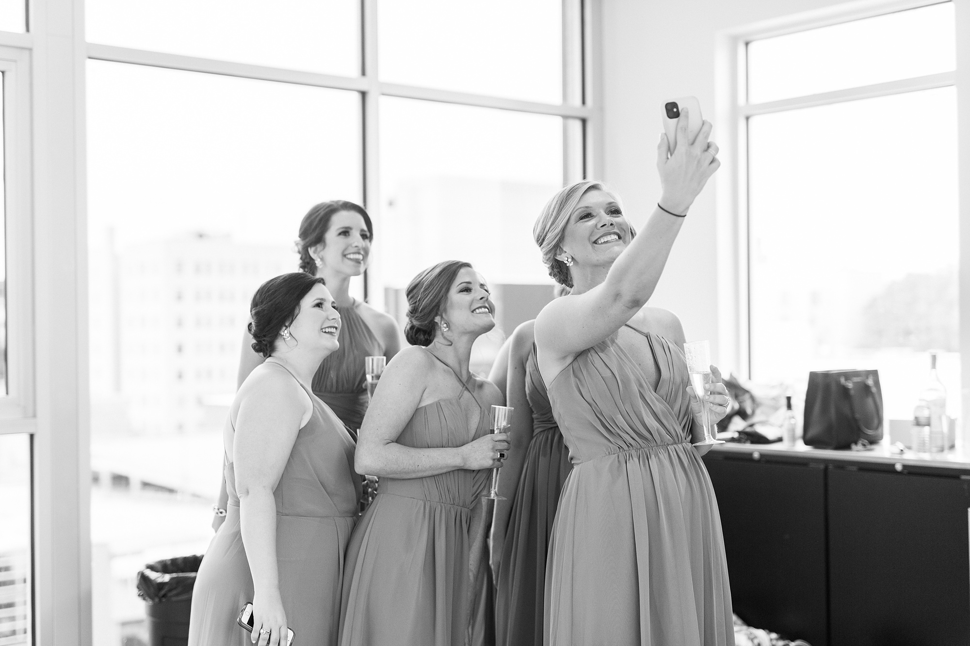 bridesmaids take selfie while preparing for Stockroom at 230 wedding