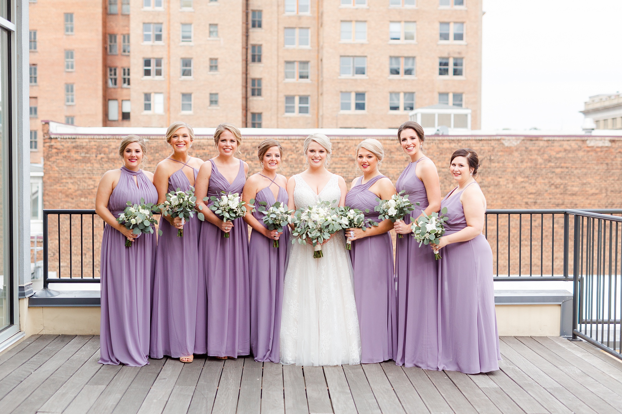 bridal party poses on rooftop in NC