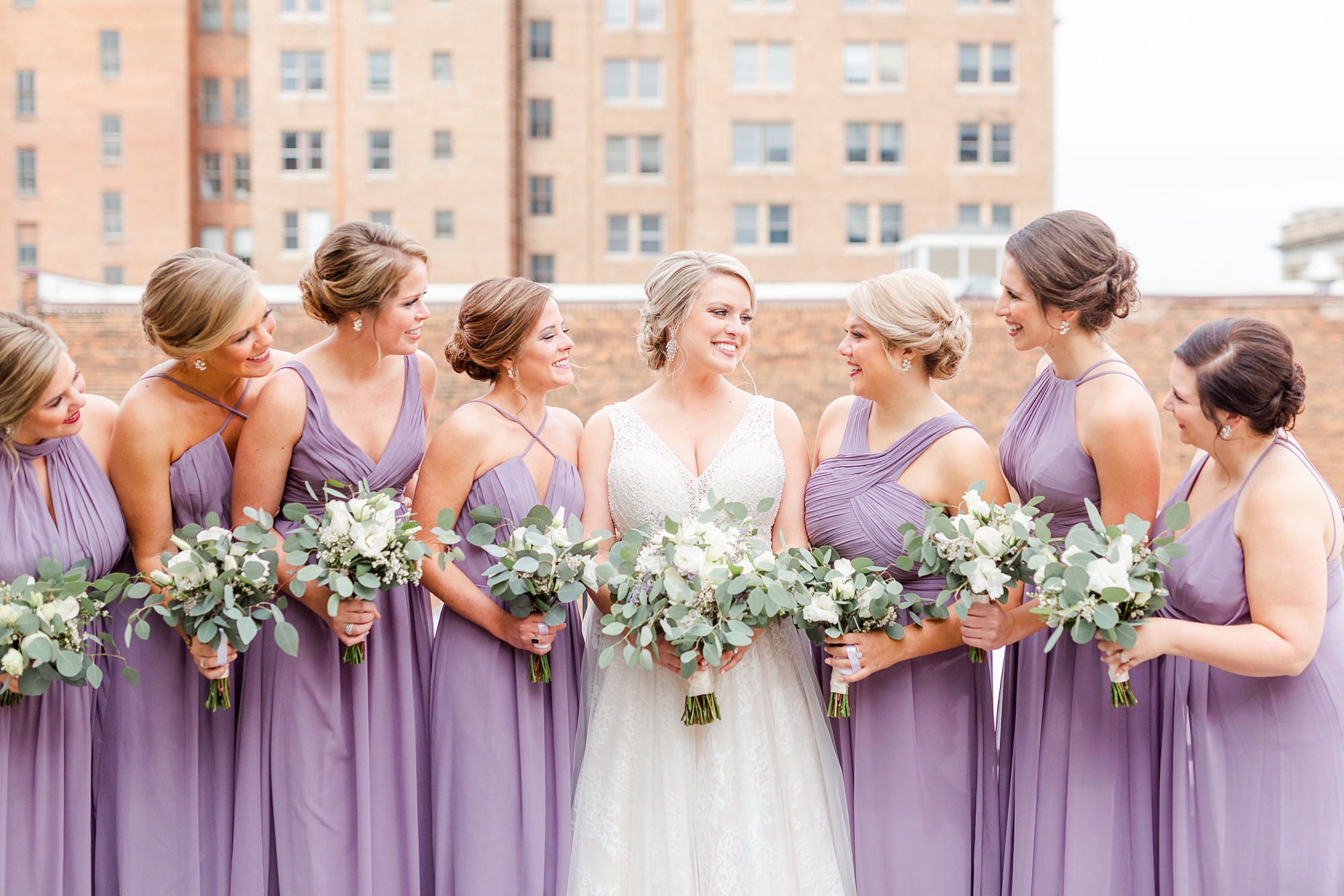 bride poses with bridesmaids in Raleigh NC