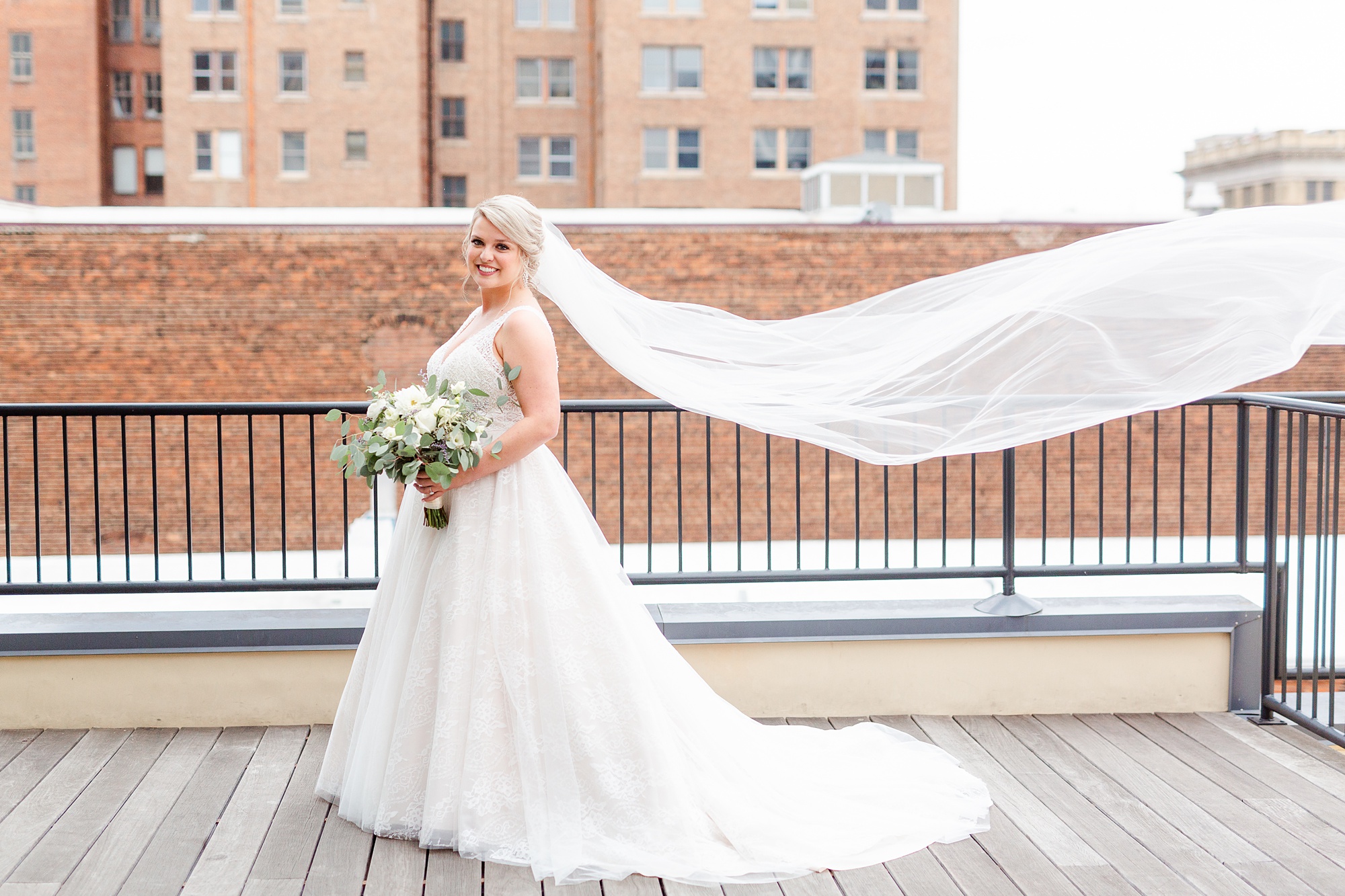 bridal portrait with veil floating during Stockroom at 230 wedding