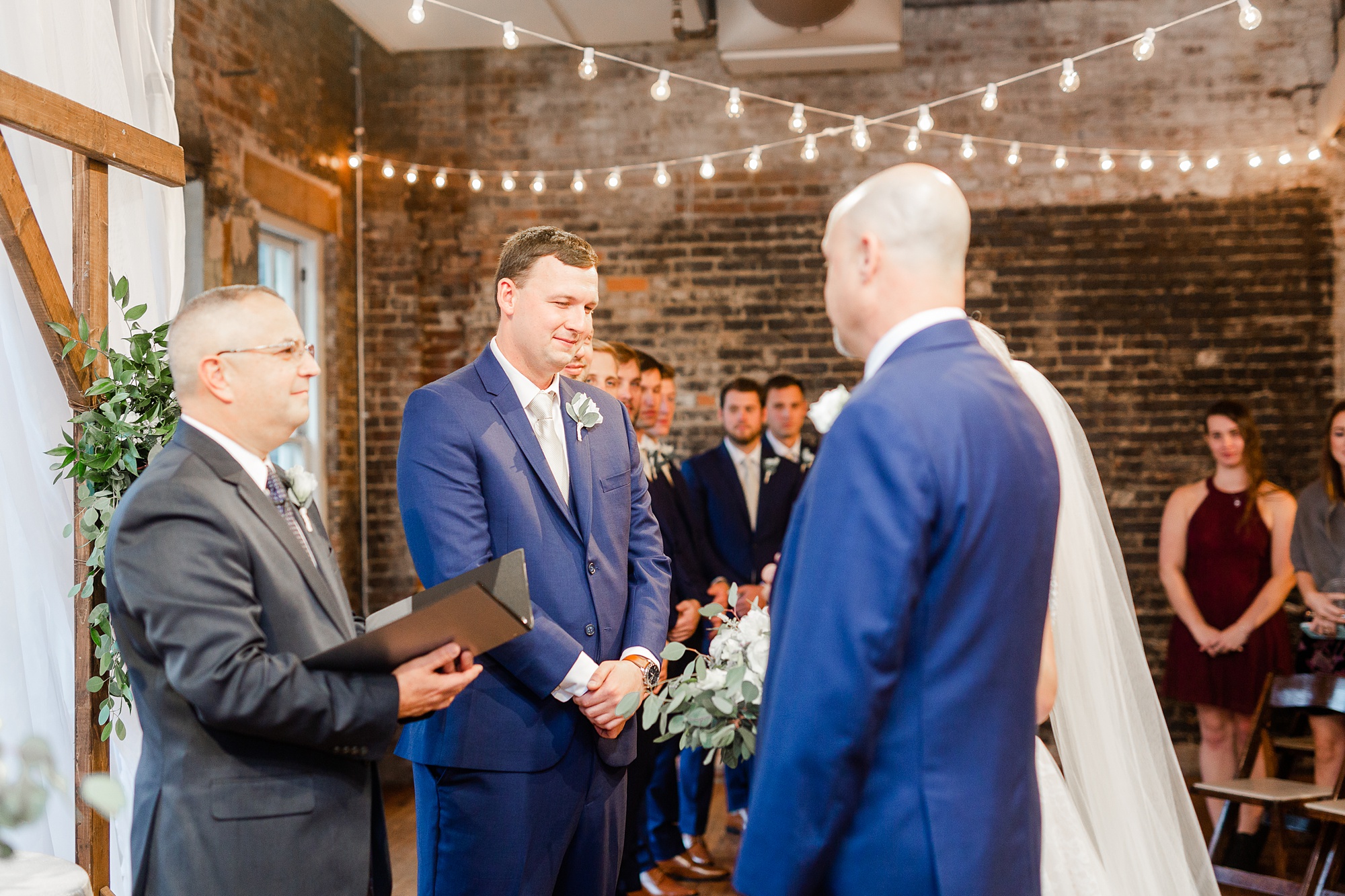 father gives bride away during wedding ceremony at Stockroom at 230