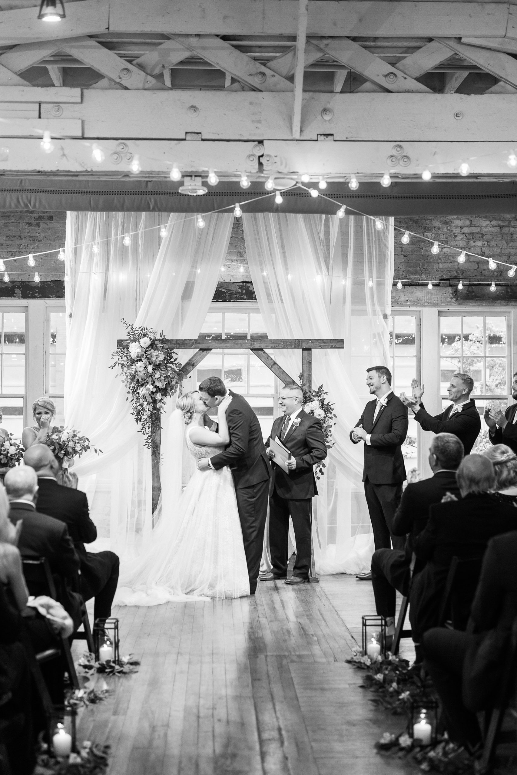 newlyweds kiss during ceremony at Stockroom at 230