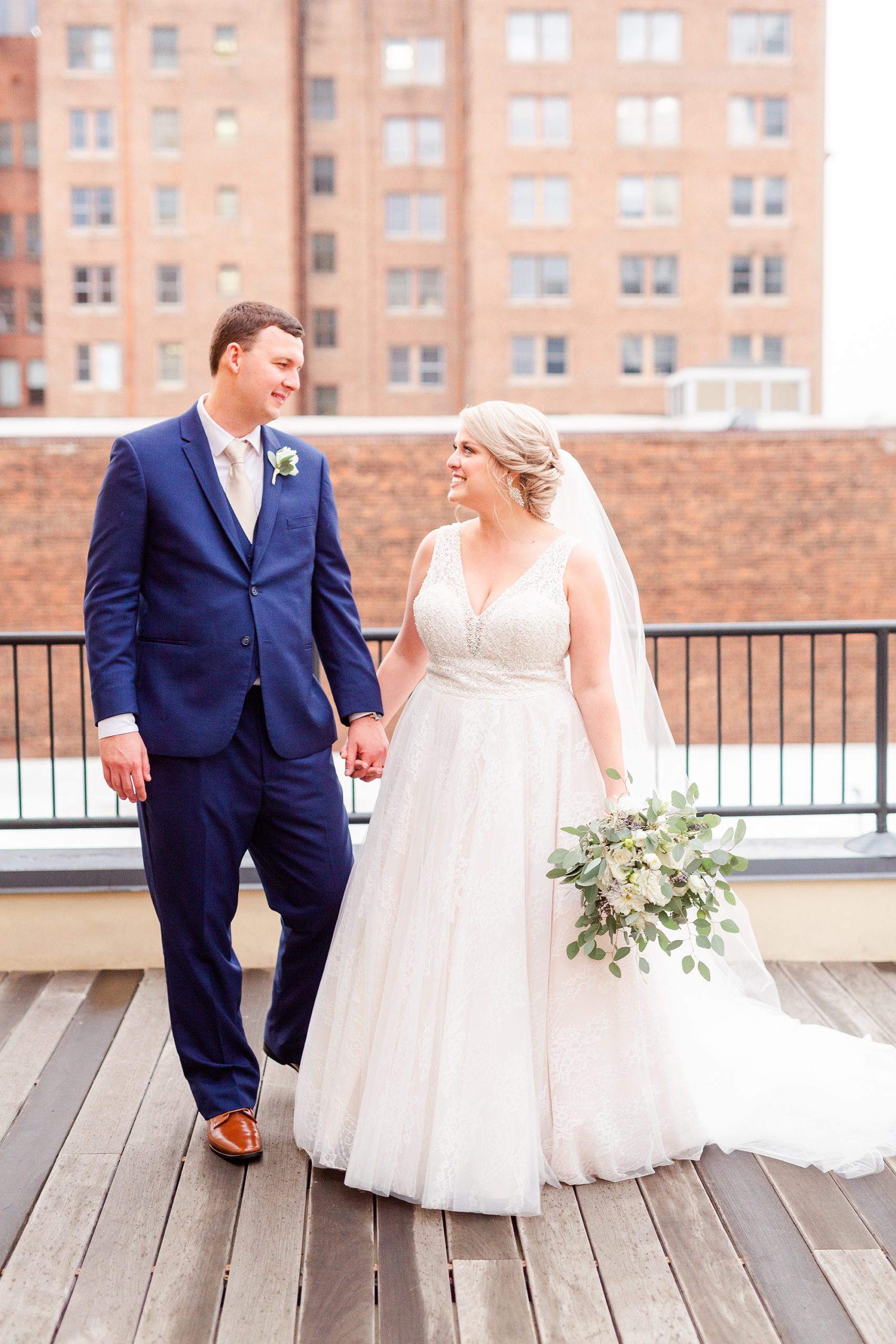 newlyweds walk on rooftop at Stockroom at 230