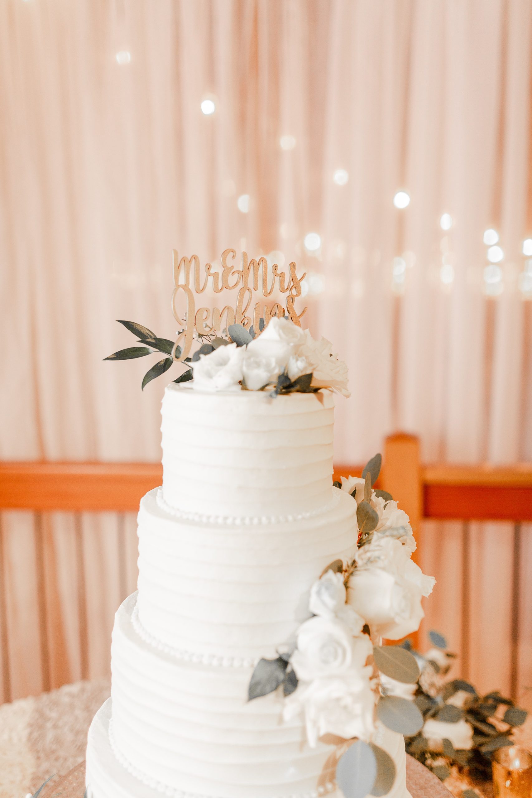 tiered wedding cake with gold topper