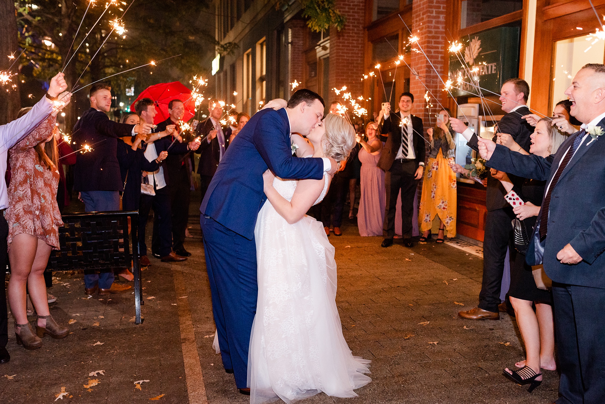 newlyweds kiss during sparkler exit at Stockroom at 230 wedding