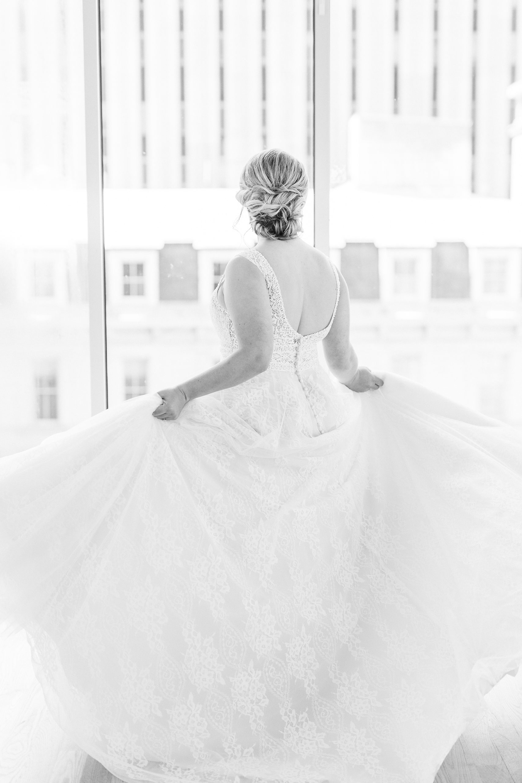 bride twirls wedding gown during photos at The Glass Box