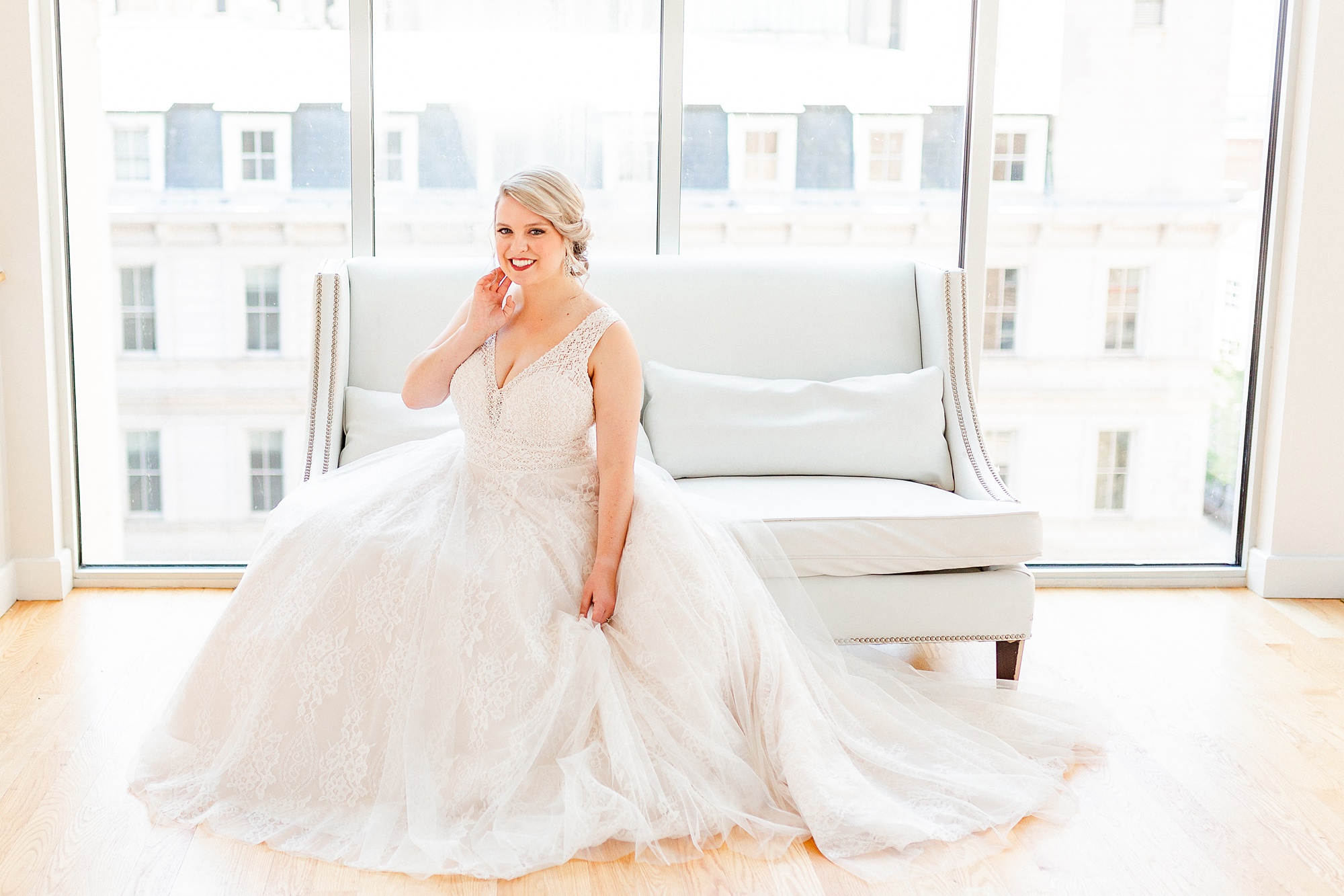 bride sits on couch in The Glass Box