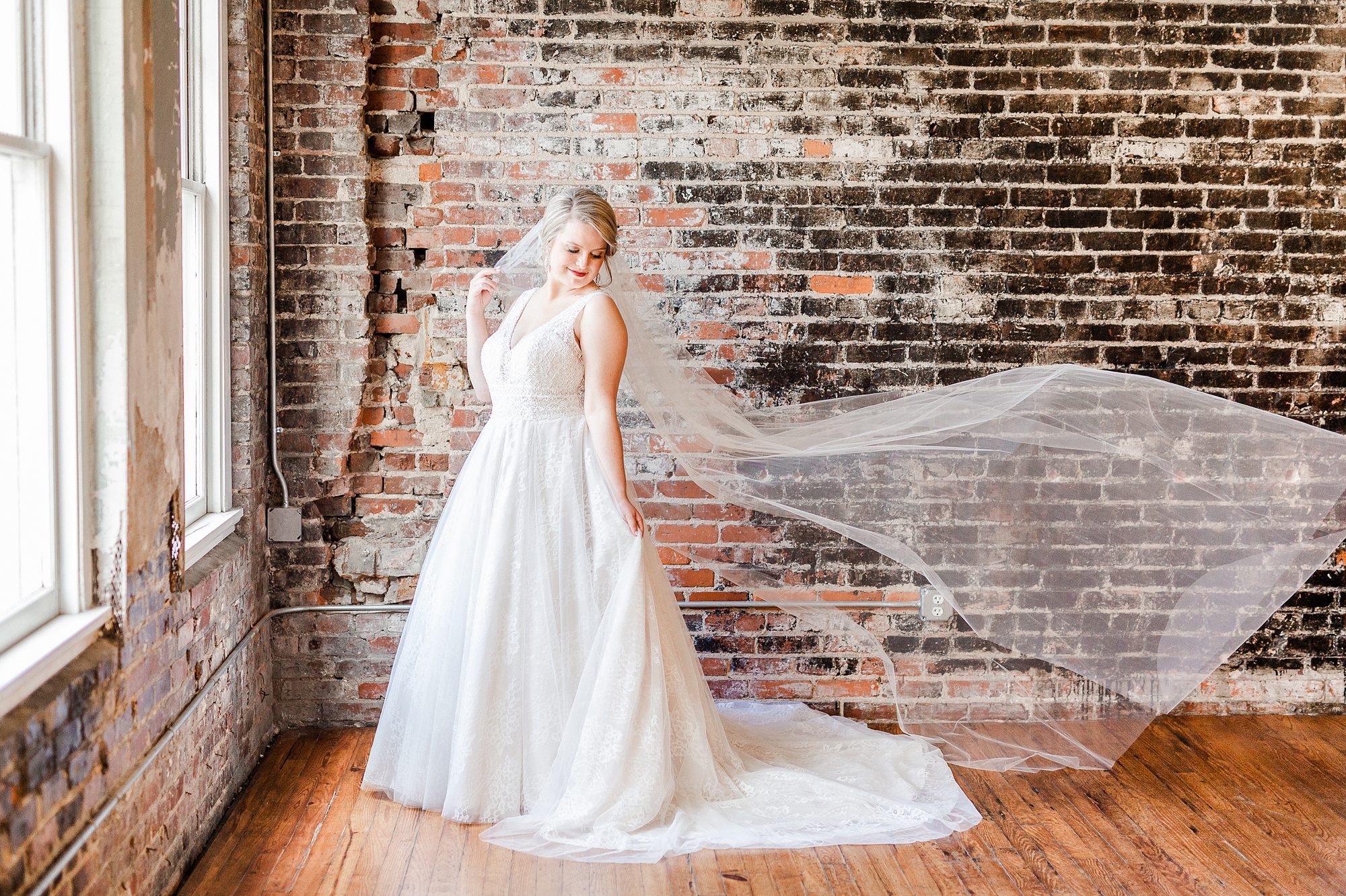 bride's veil floats during portraits at The Stockroom at 230