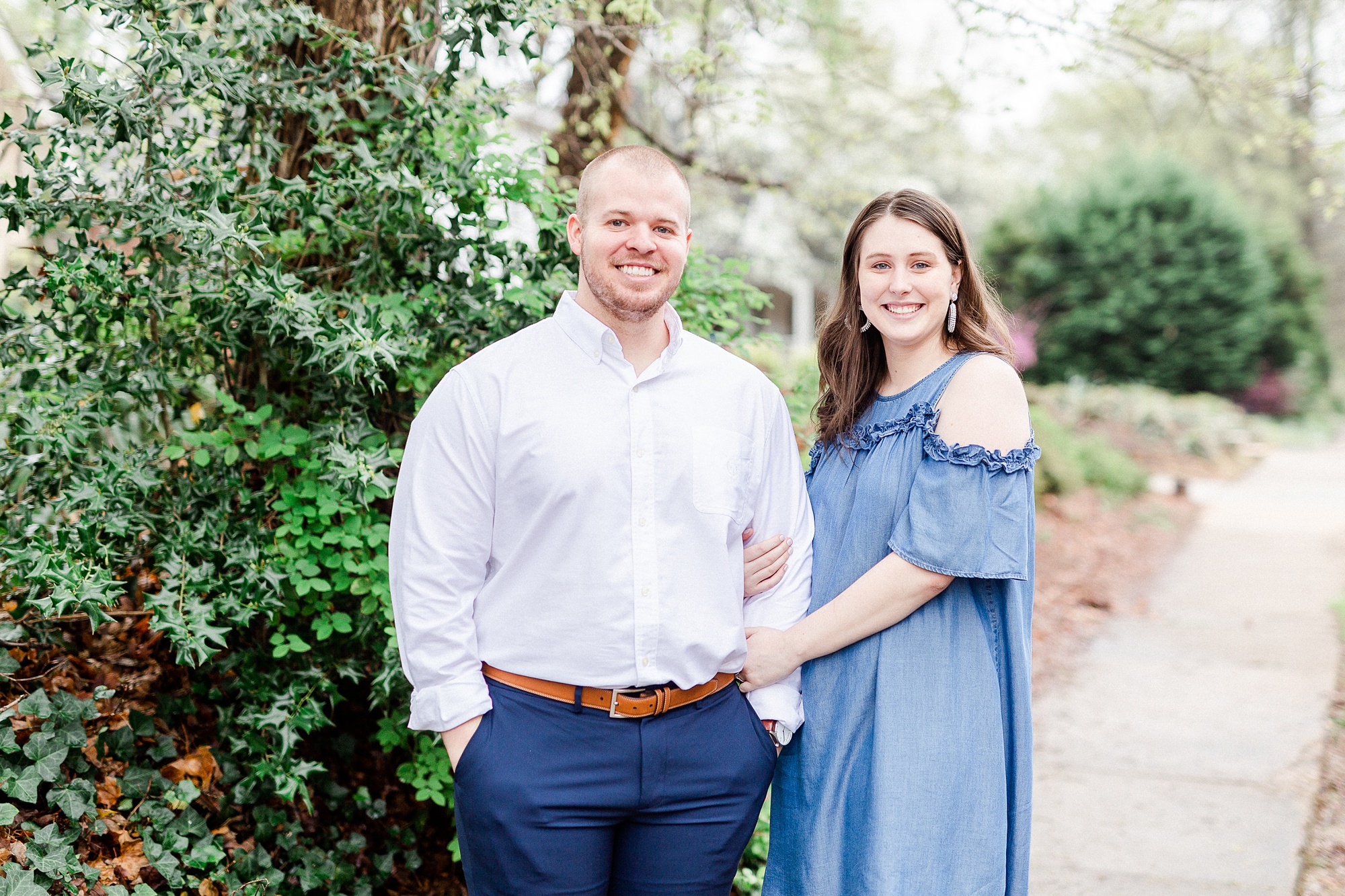 bride and groom pose during Downtown Davidson NC Engagement