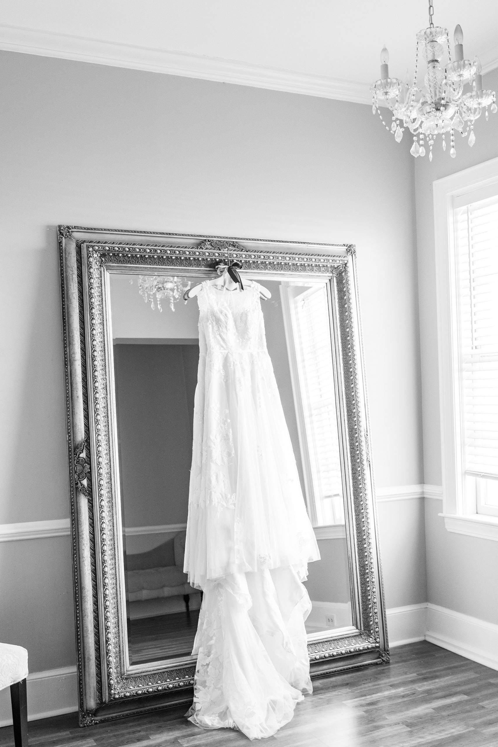 bride's dress hangs on mirror in bridal suite at Separk Mansion
