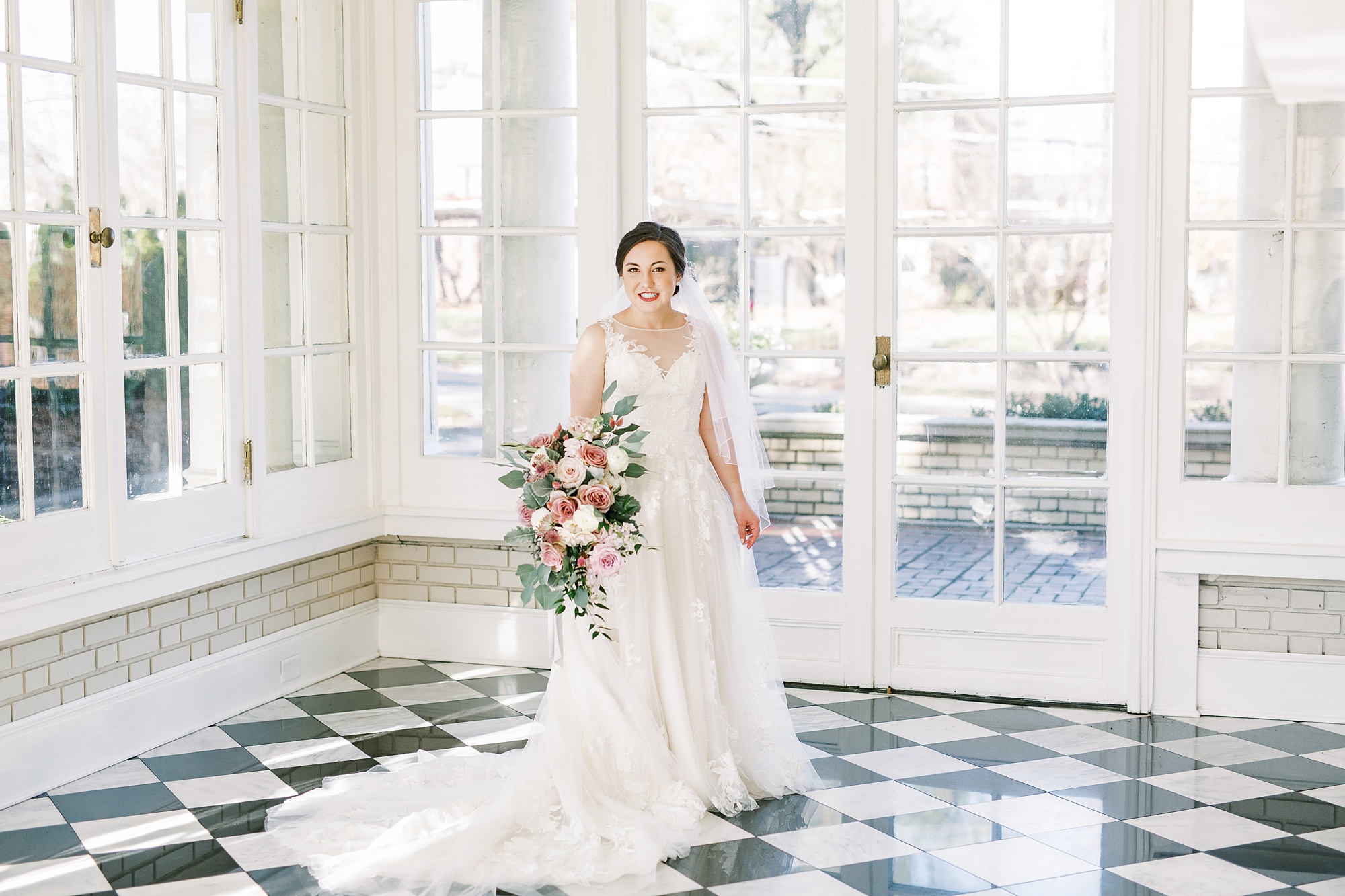 bride in classic wedding gown with mother's veil poses in Separk Mansion