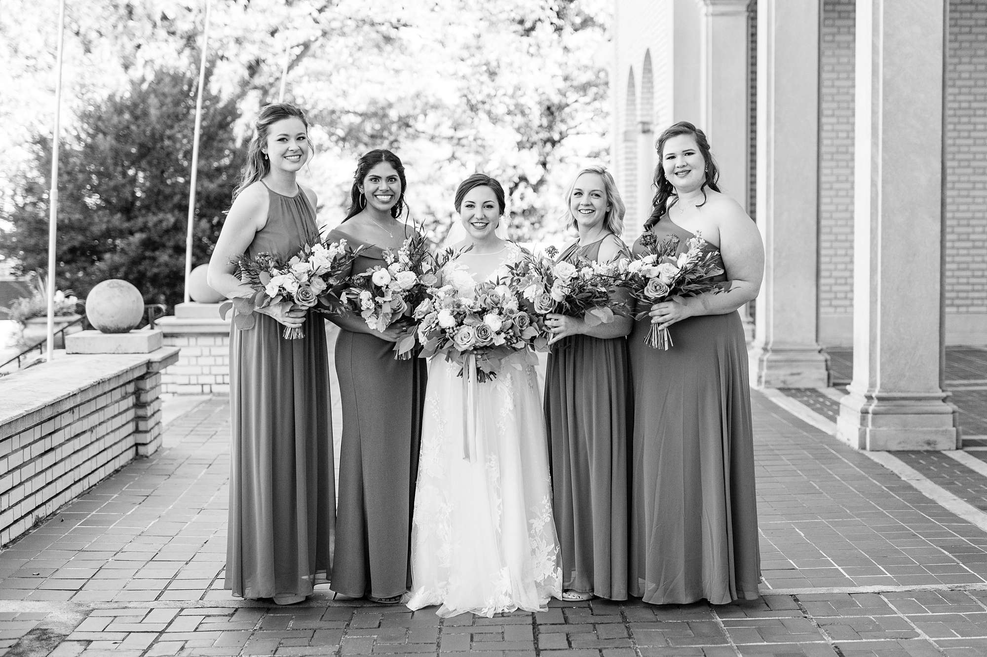 bride poses with four bridesmaids outside Separk Mansion