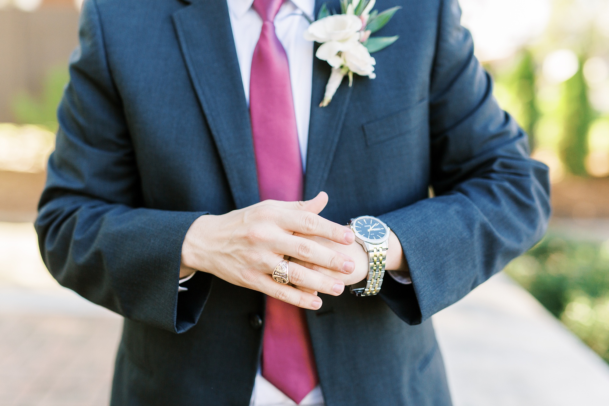 groom adjusts watch for wedding attire