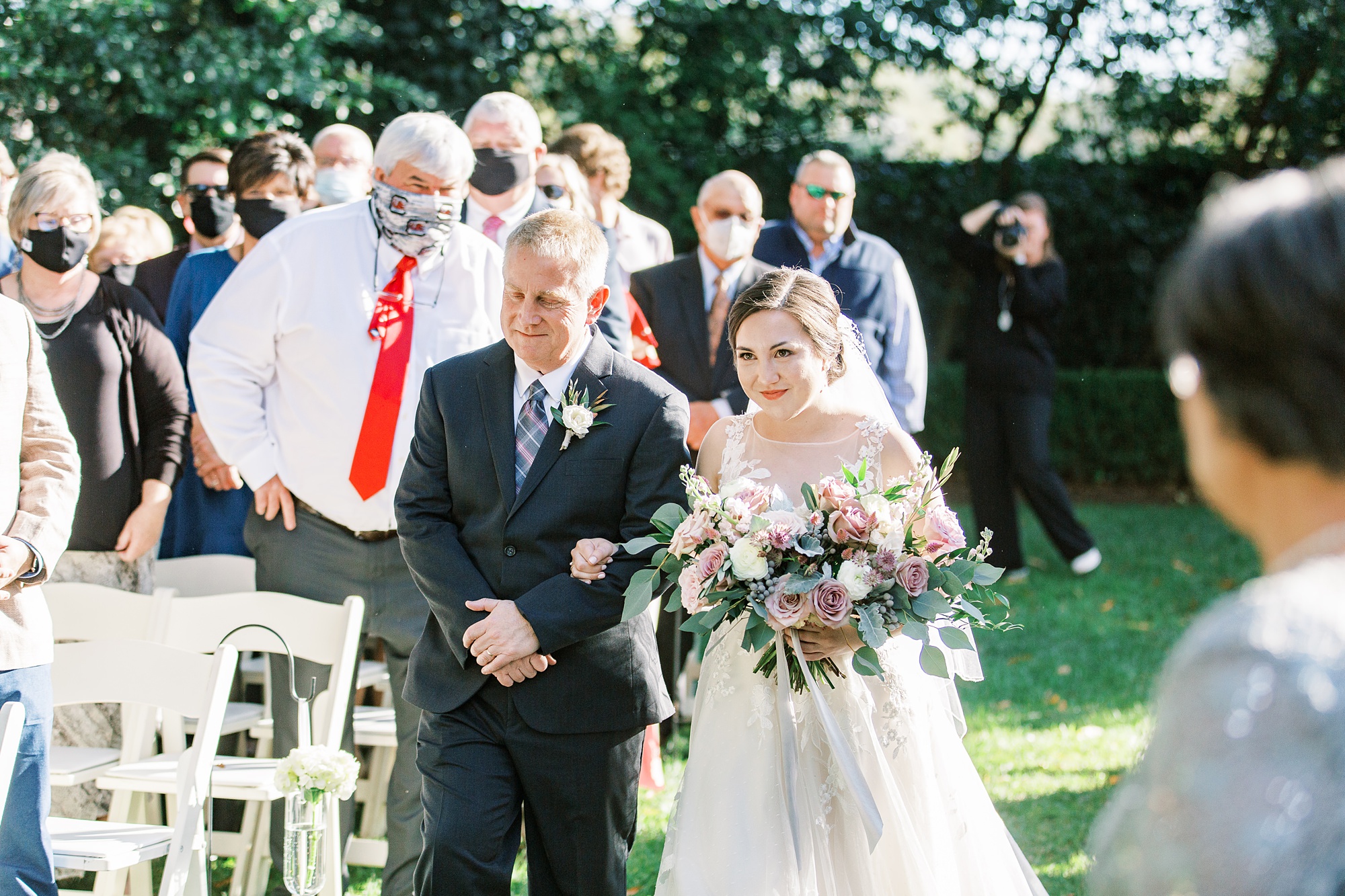 bride and father walk down aisle in Charlotte NC