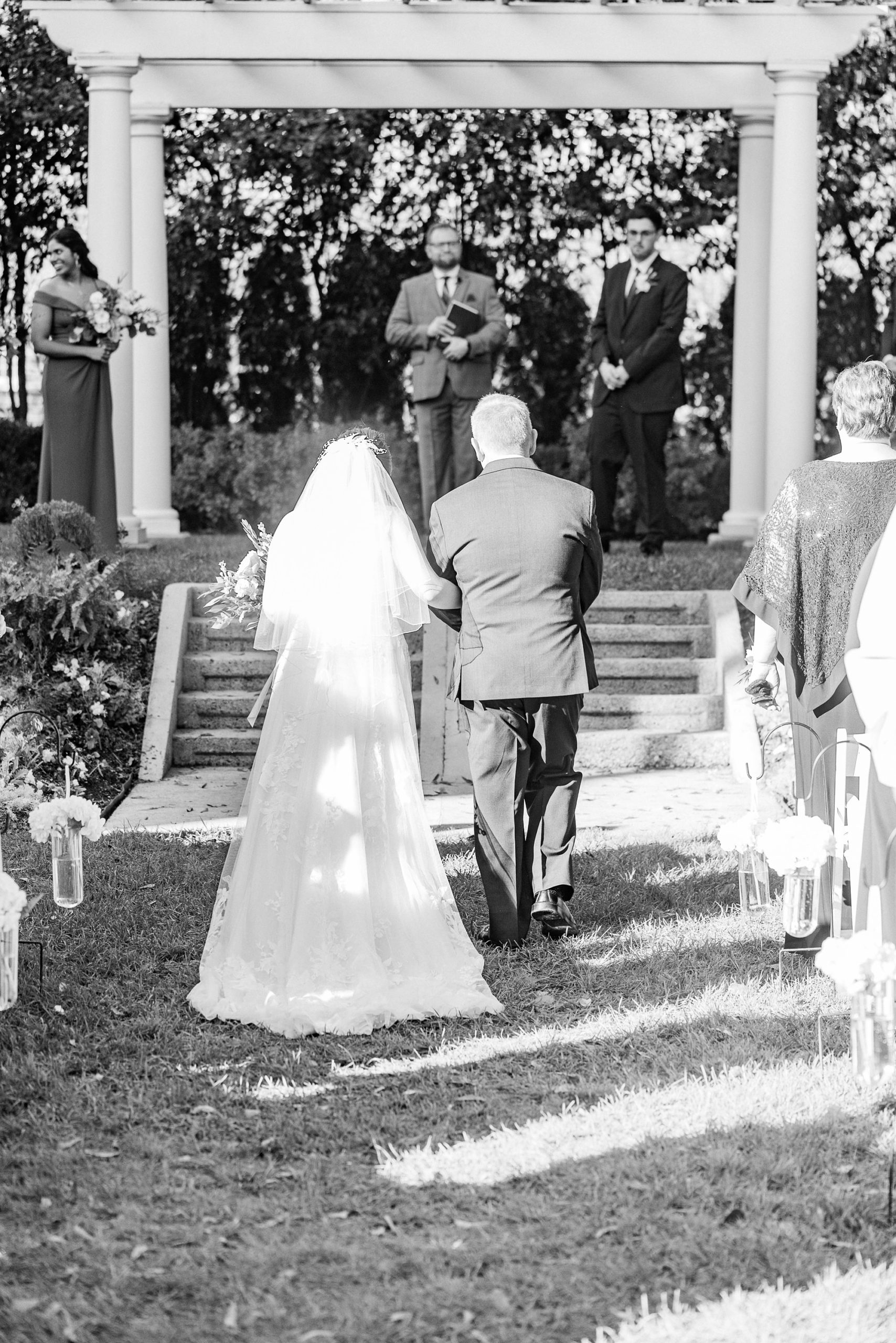 father gives bride way during outdoor fall wedding ceremony