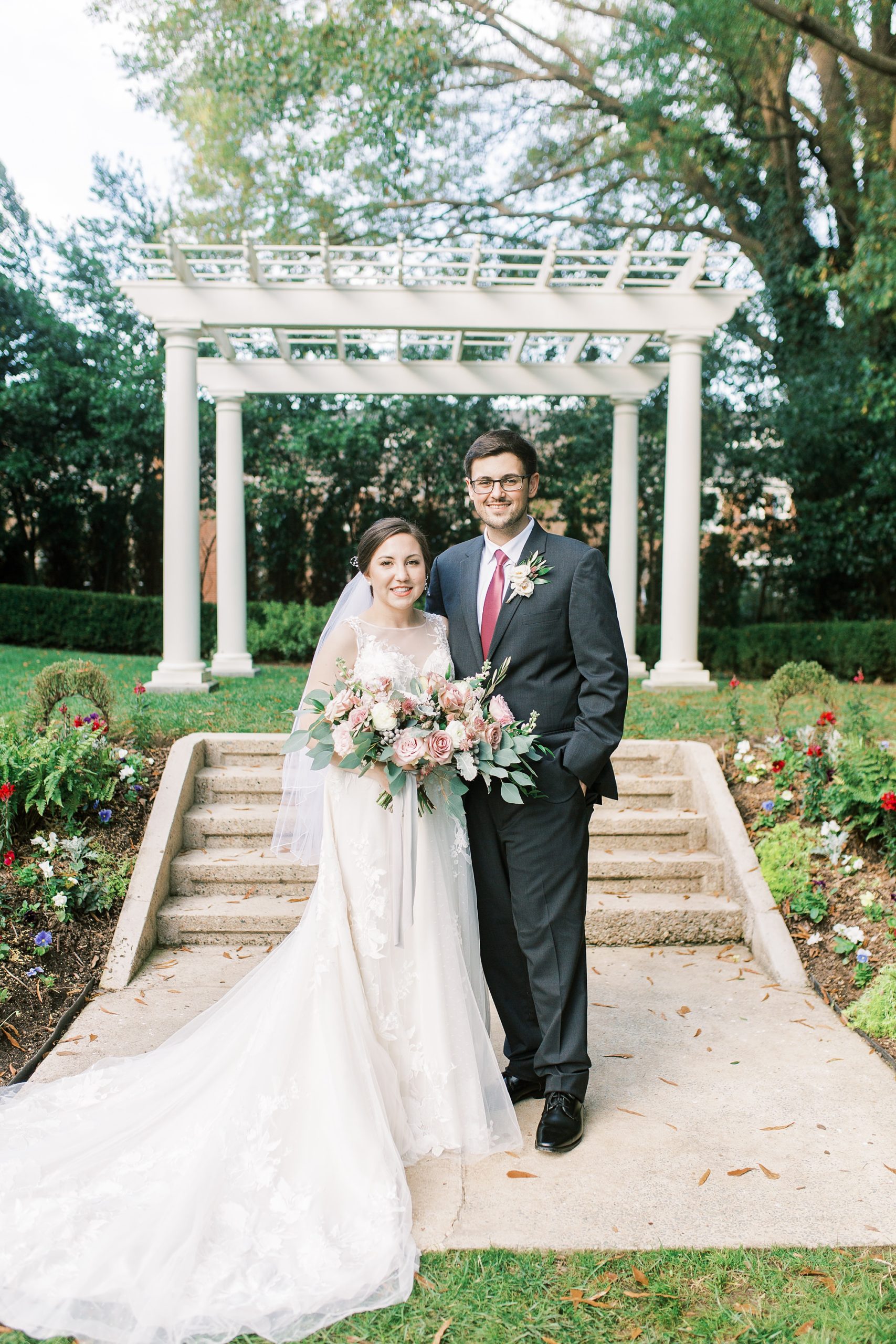 bride and groom pose by arbor at Separk Mansion