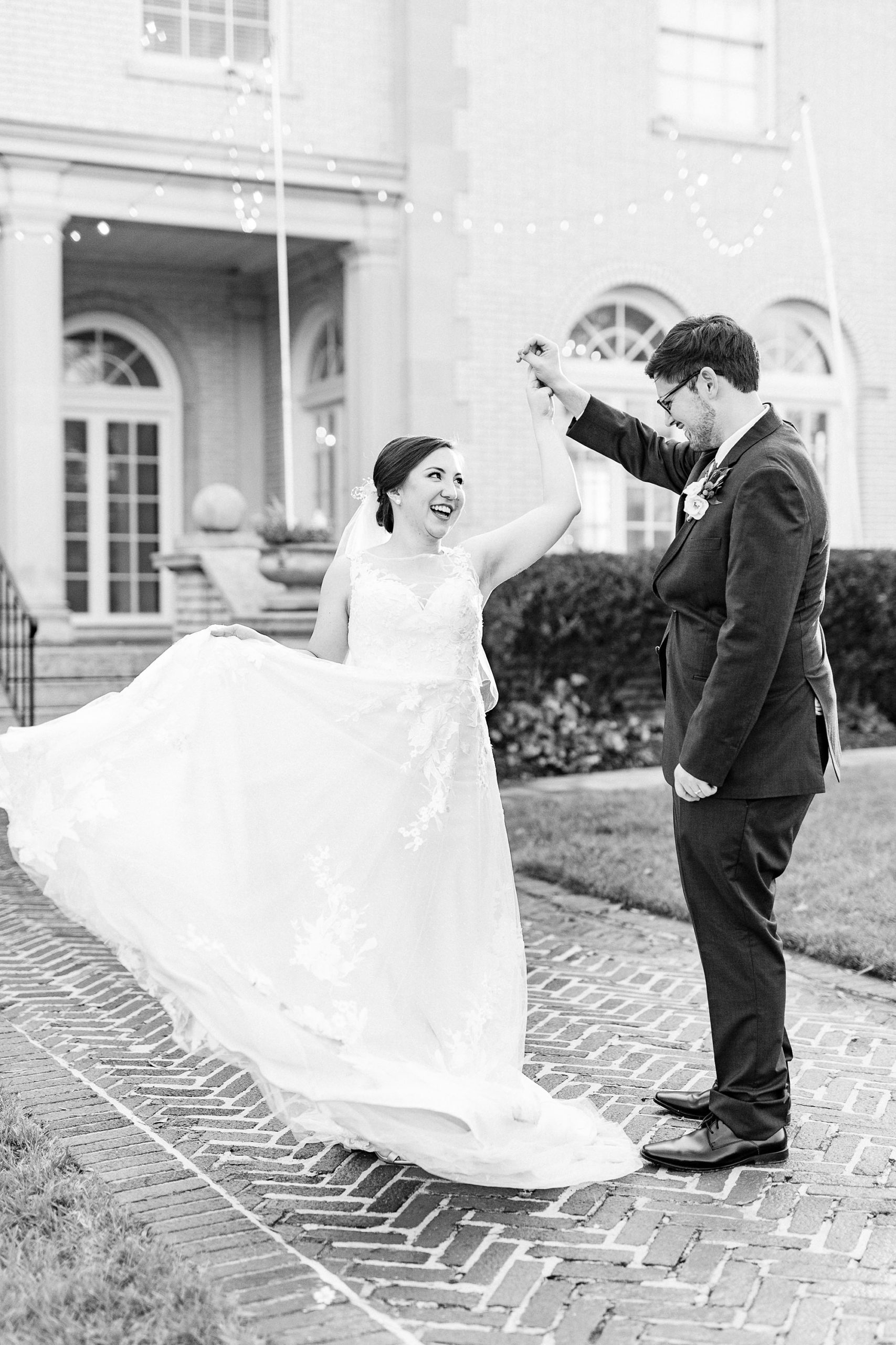 groom twirls bride during wedding photos at Separk Mansion
