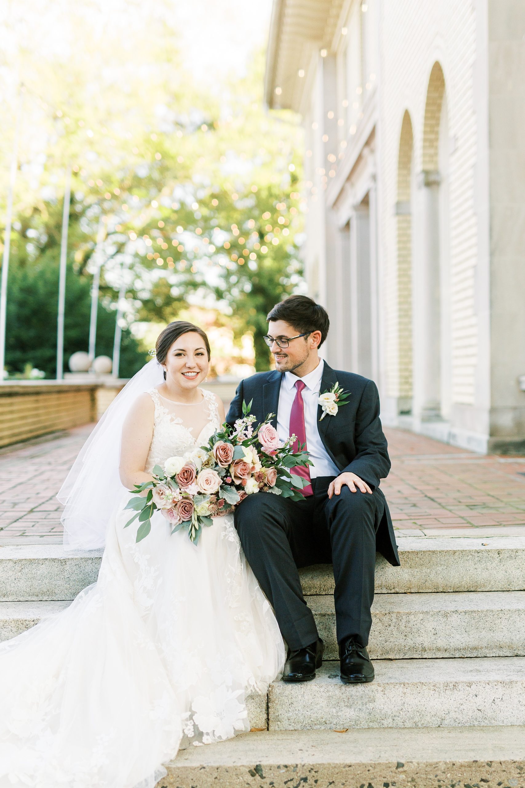 bride and groom sit together on steps at Separk Mansion