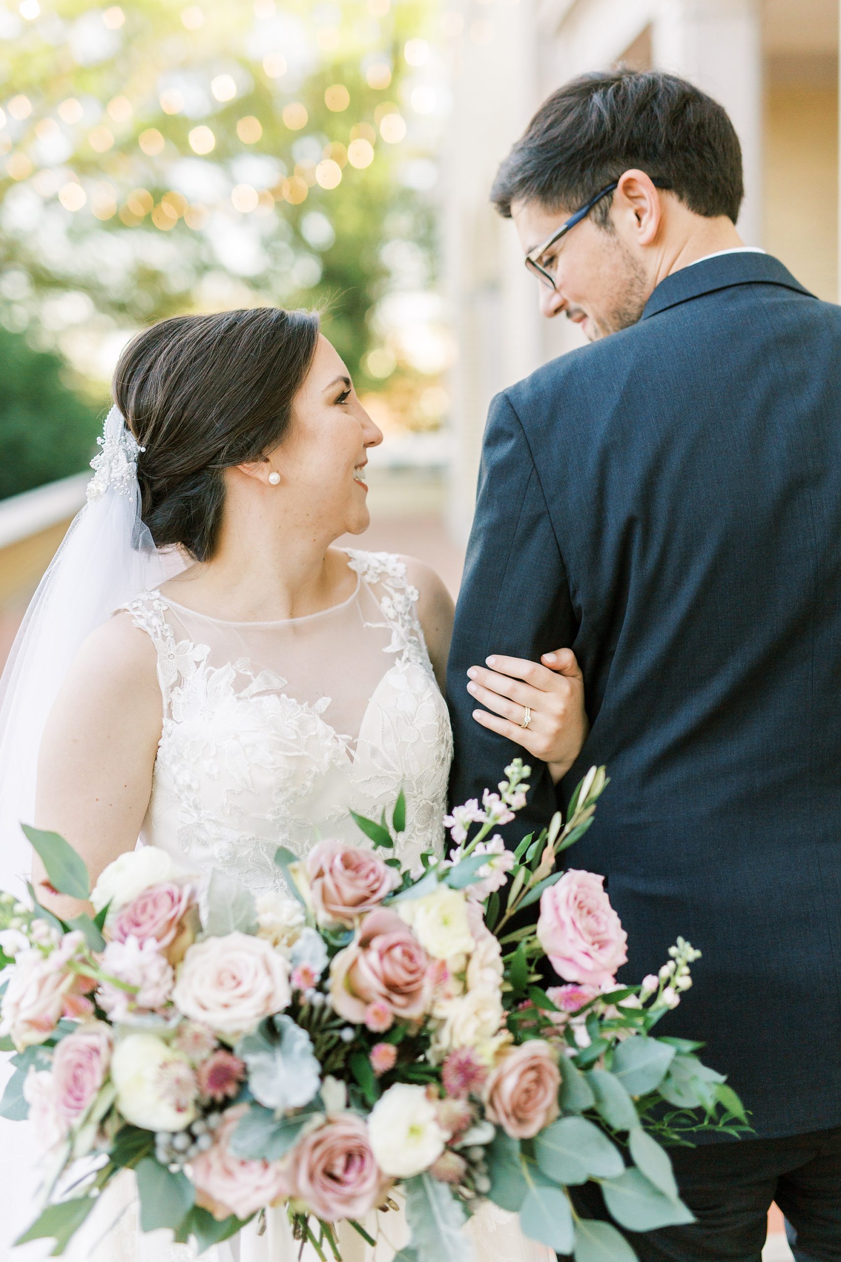bride and groom look at each other during mauve fall wedding portraits