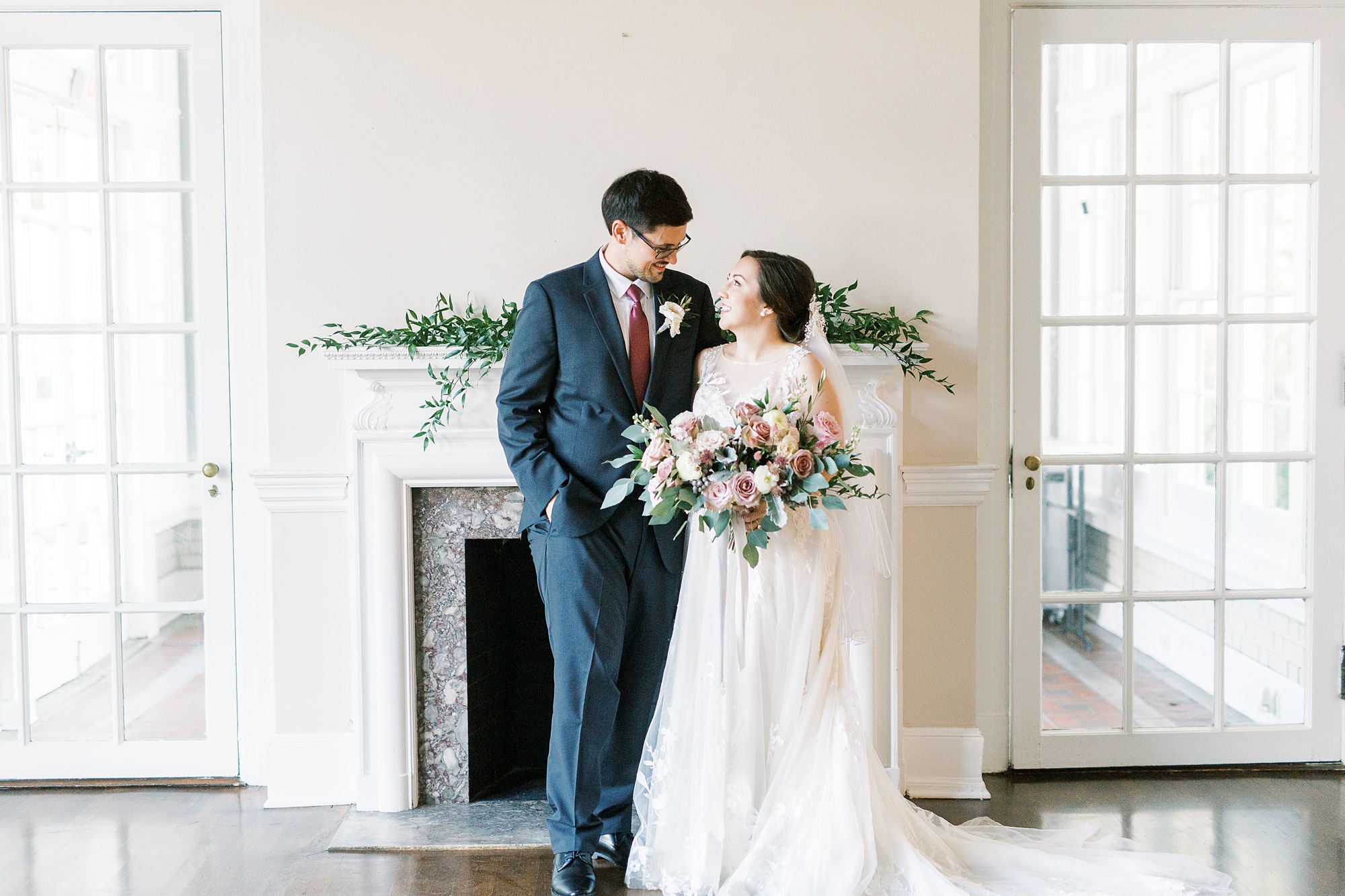 newlyweds pose in front of fireplace at Separk Mansion