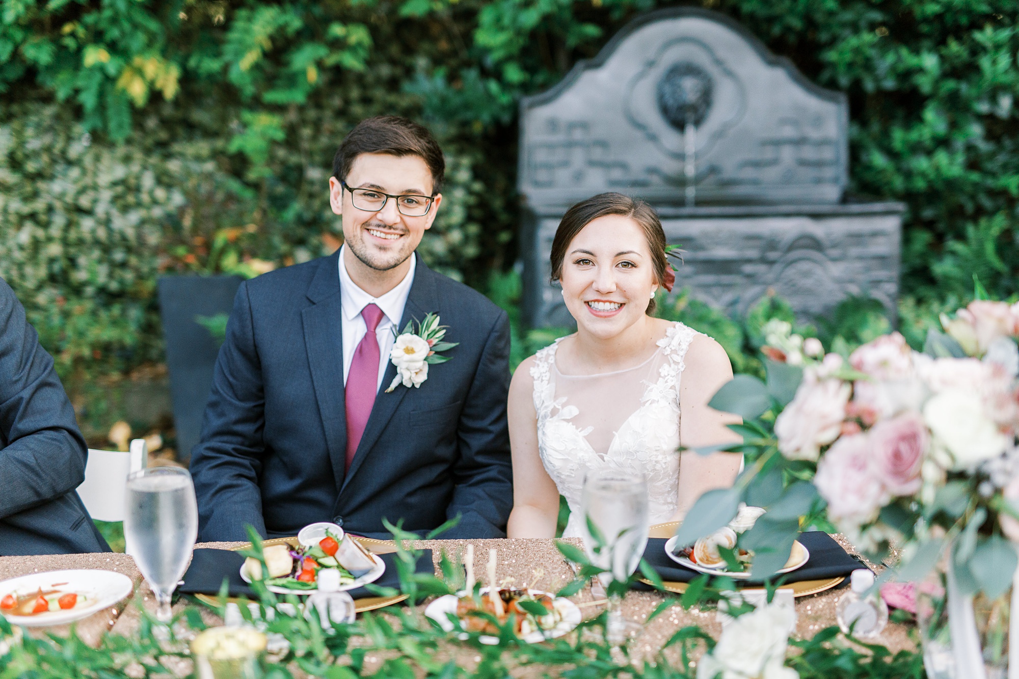 bride and groom sit at head table during outdoor reception at Separk Mansion
