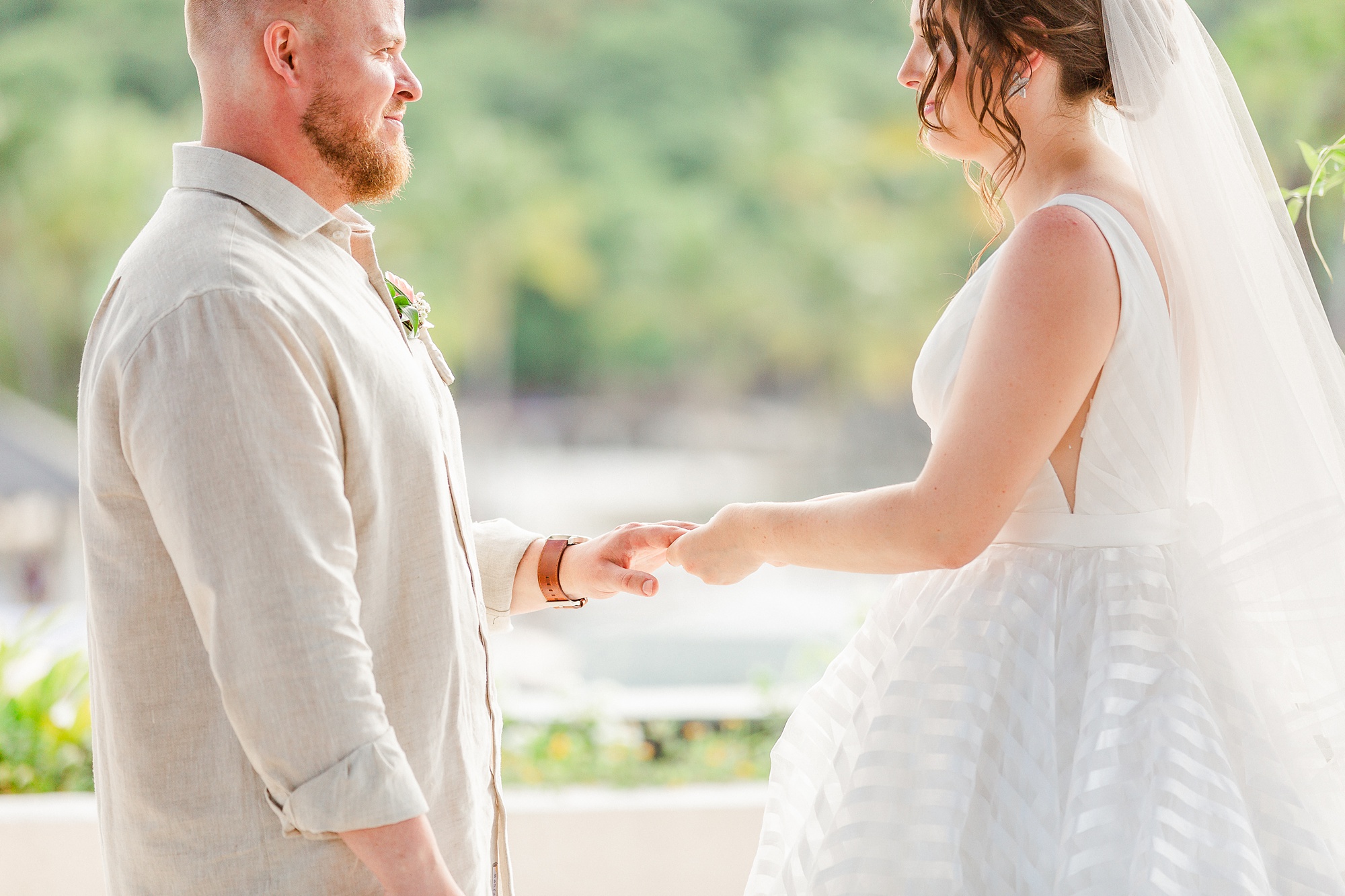 bride exchanges rings with groom during St Lucia resort wedding ceremony