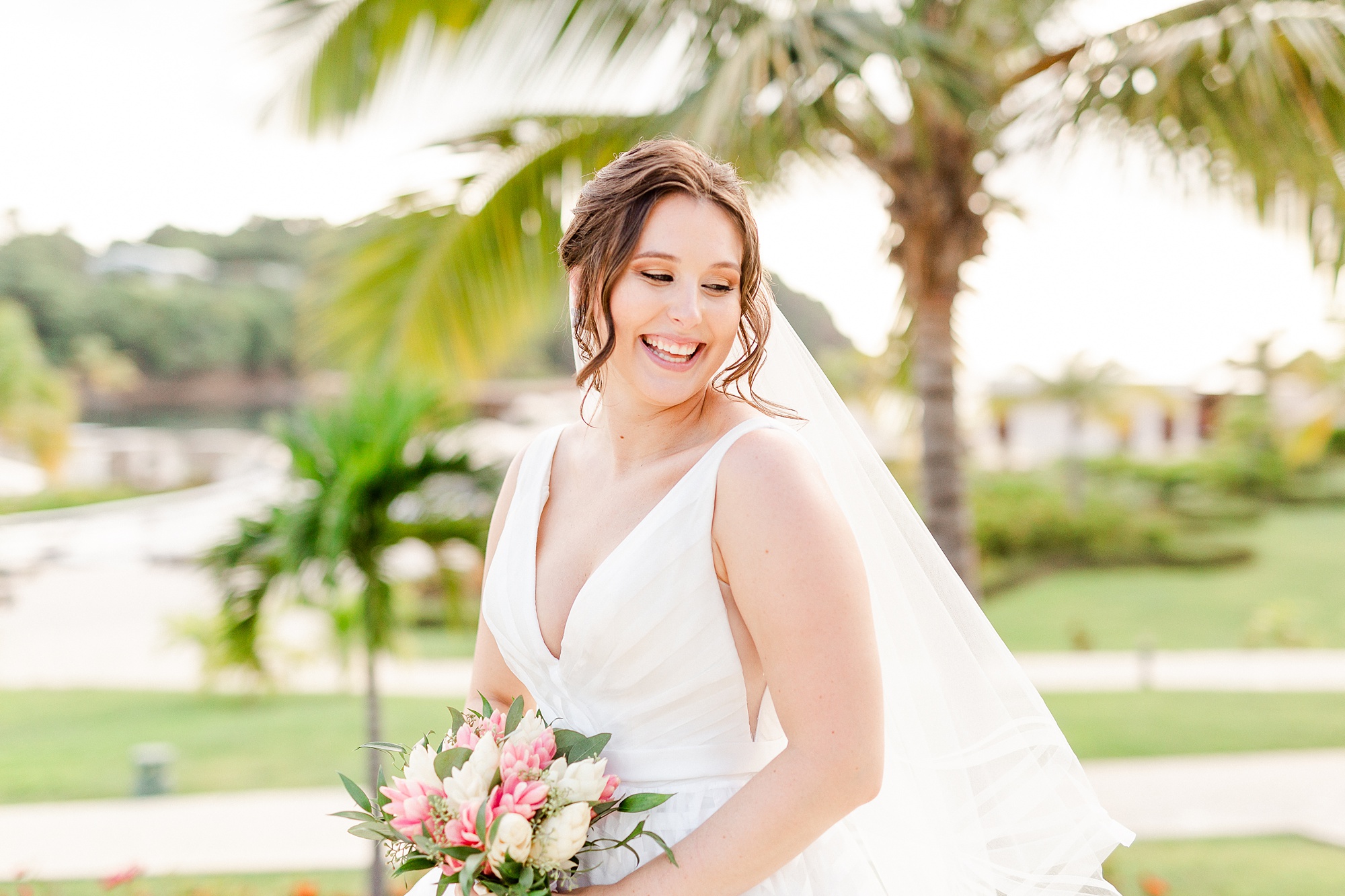 bride laughs looking over shoulder during bridal portraits in St Lucia