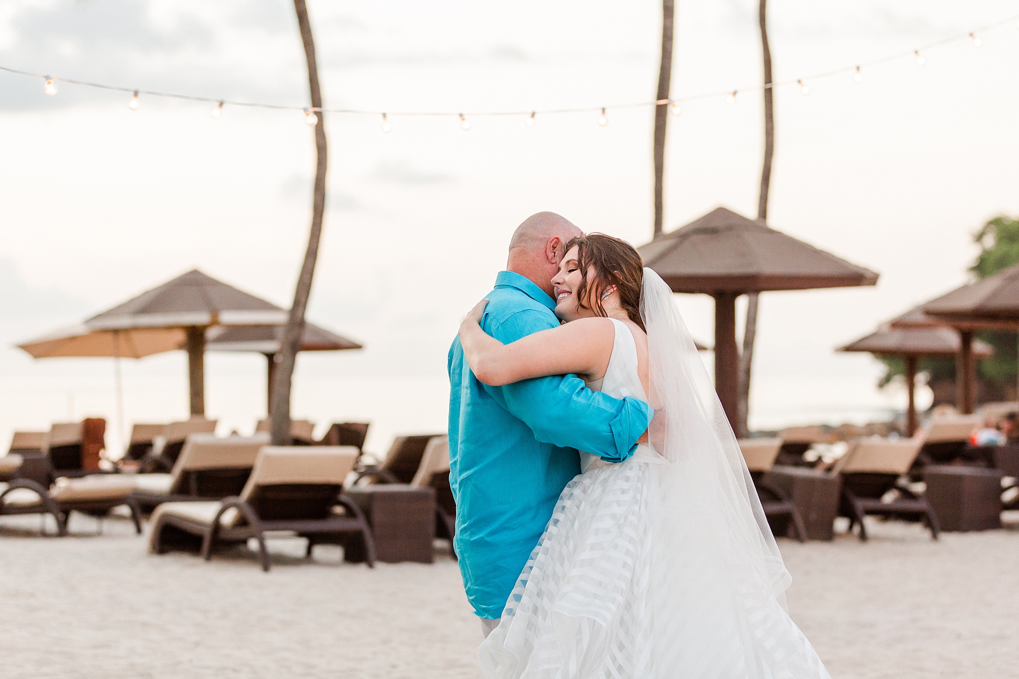 bride and dad dance during beach reception