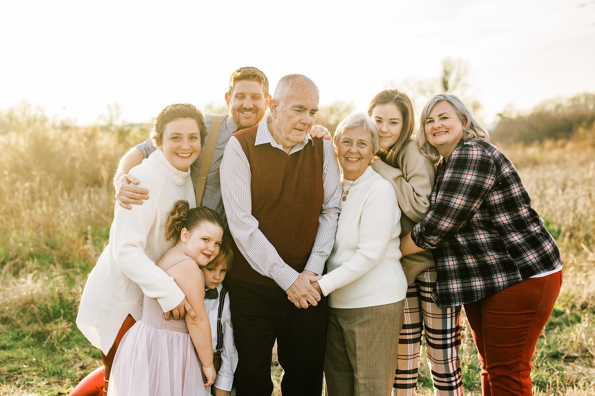family hugs grandparents during NC anniversary portraits