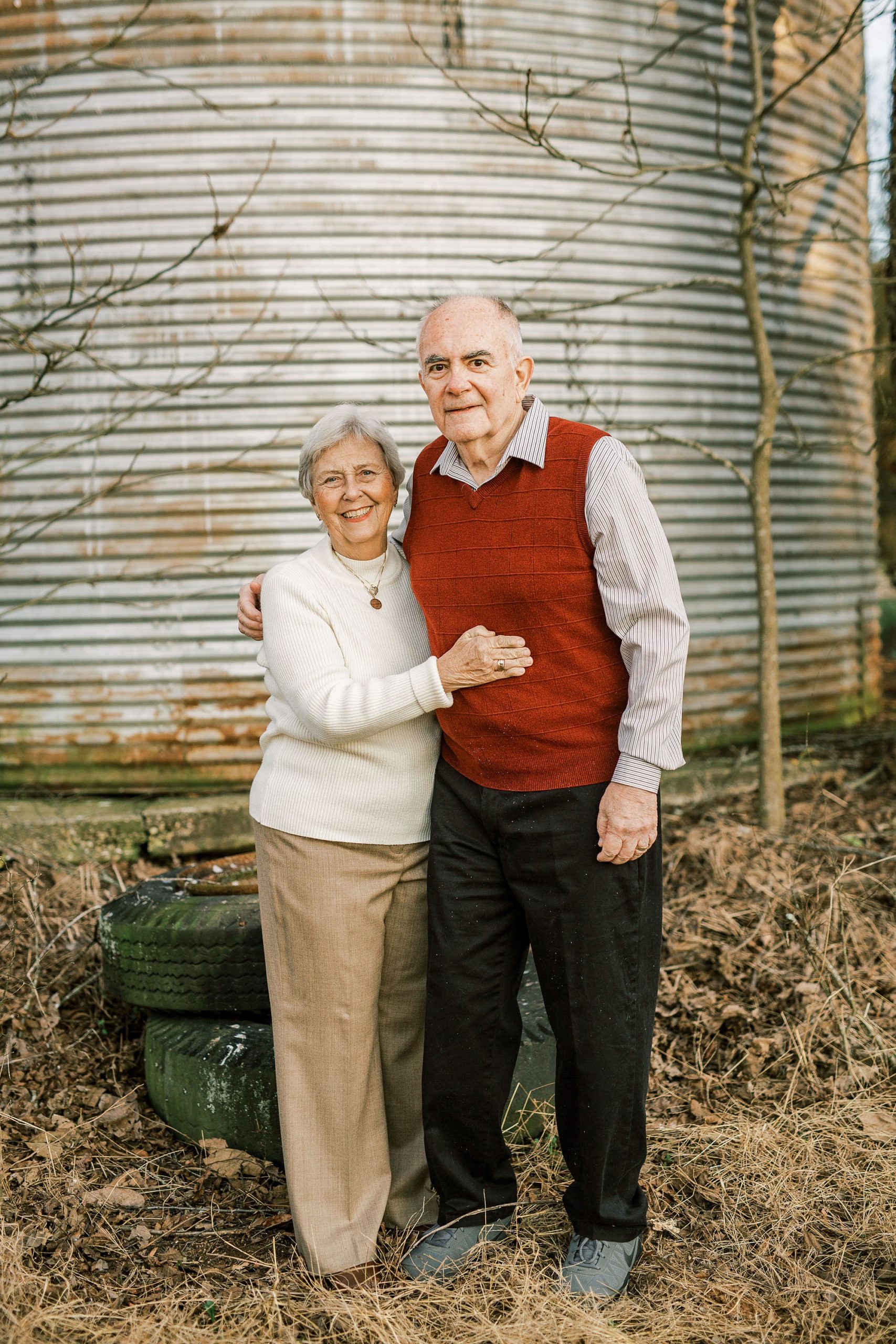 couple hugs by silo during 50th anniversary photos