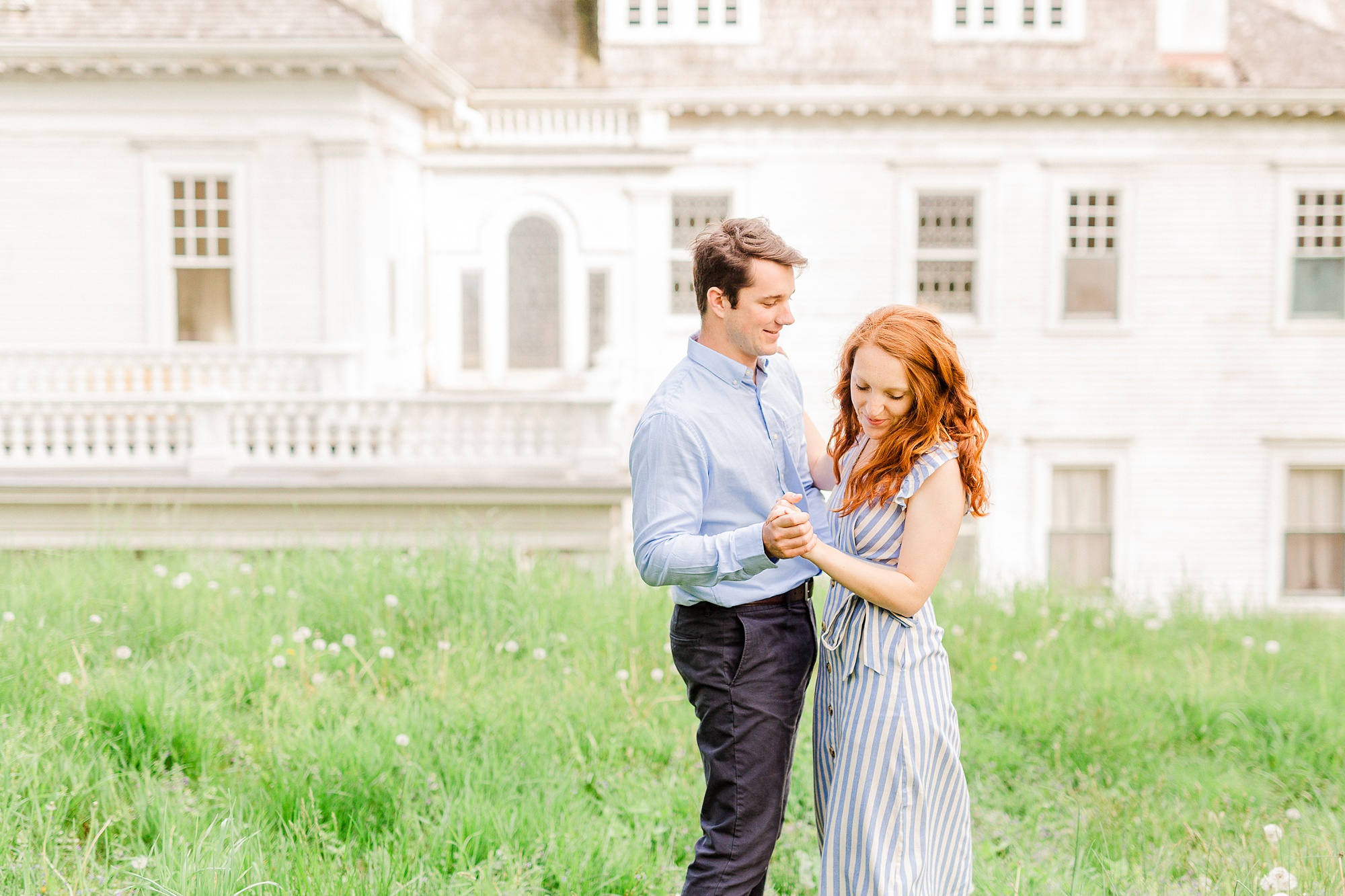 bride and groom dance in field at Moses Cone Manor during Boone NC spring engagement photos